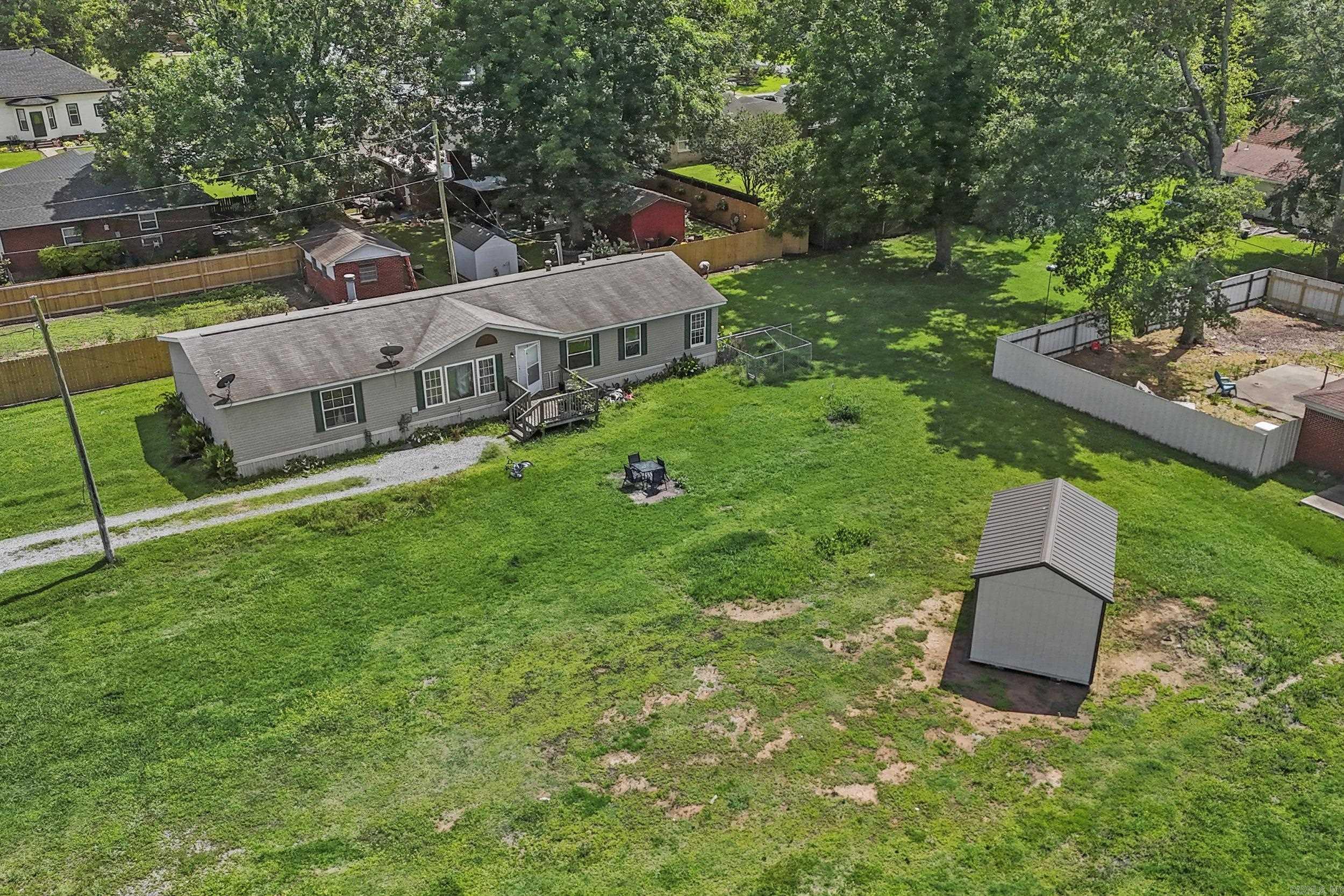 Welcome to this large 1,716 sq ft mobile home with 3 bedrooms, 2 bathrooms that is perfectly situated on a large lot. It includes the lot it is on and the corner lot next to it with 319 as its address. The home comes with a clear Title and is on concrete runners with tie down straps. This is on a permanent foundation. It features an open floor plan, a fireplace, the kitchen has a large pantry, stainless steel appliances, and a breakfast bar, & plenty of storage. It has an oversized private primary bedroom, walk-in closet, & primary bath that has a large shower and tub. Outside you will find a newer 6X10 storage shed for all your tools and extras. It is close to schools, in Lonoke County, has Entergy service, Carlisle city Water and has High speed internet available.***Seller is offering a $5,000.00 flooring allowance***Make this your home today!!