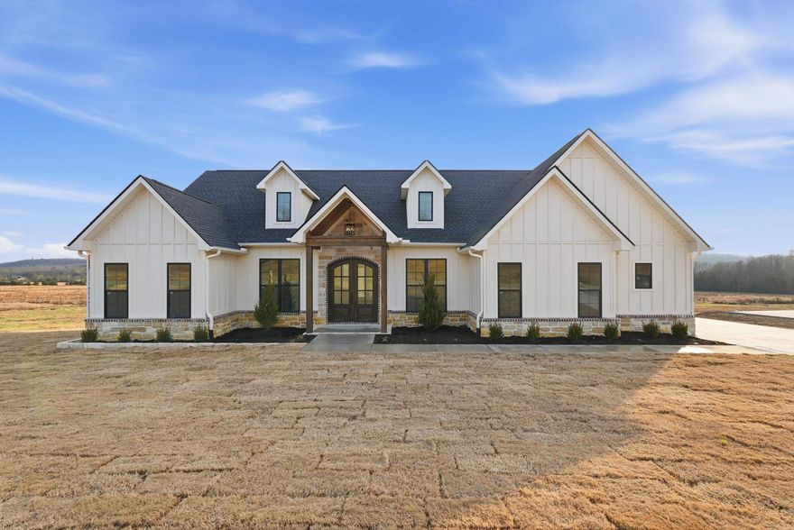 Designed for comfort and everyday enjoyment, this custom-built new construction offers 2,403 sq ft on a spacious 0.75-acre lot with 3 bedrooms plus an office and 2.5 baths. The open floor plan is filled with natural light and features vaulted ceilings, LVP and tile flooring throughout, quartz countertops, and a cozy gas log fireplace. The kitchen is both stylish and functional with custom cabinetry, stainless steel appliances, a gas range, and pantry, flowing seamlessly into the main living space. The primary suite serves as a private retreat with a stand-up tiled shower and relaxing soaker tub. Additional highlights include a safe room, dedicated laundry room with sink, mudroom area, tankless gas water heater, and a covered back patio perfect for unwinding or entertaining. Gas appliances include the range, fireplace, and water heater. Loaded with thoughtful upgrades, this home is a must-see. Agent see remarks.