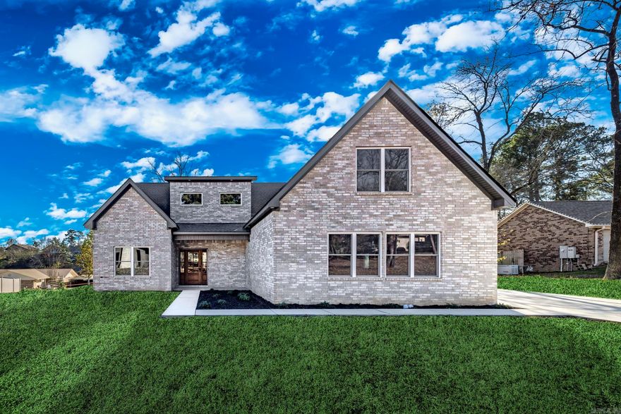 Welcome to your dream home at 168 Pico Circle in Hot Springs, Arkansas. This stunning new construction features four spacious bedrooms and three full baths, accompanied by a versatile bonus den and dedicated office space, perfect for modern living. The open-concept design seamlessly connects the living area and kitchen, creating an inviting space ideal for entertaining and family gatherings.Step into the kitchen, where contemporary finishes and generous counter space make meal preparation a delight. The kitchen flows effortlessly into the living area, which boasts a striking wood-beamed ceiling and large windows that fill the space with natural light. A cozy fireplace adds warmth and character, making it perfect for relaxation.The primary bath is a true sanctuary, featuring a freestanding soaking tub, dual vanities, and a beautifully tiled walk-in shower designed for comfort and elegance. You'll appreciate the sleek design and thoughtful storage solutions.Located in a desirable subdivision with lake access, this home offers a tranquil living environment and opportunities for outdoor activities.Embrace the serene surroundings and community amenities that make this area truly special