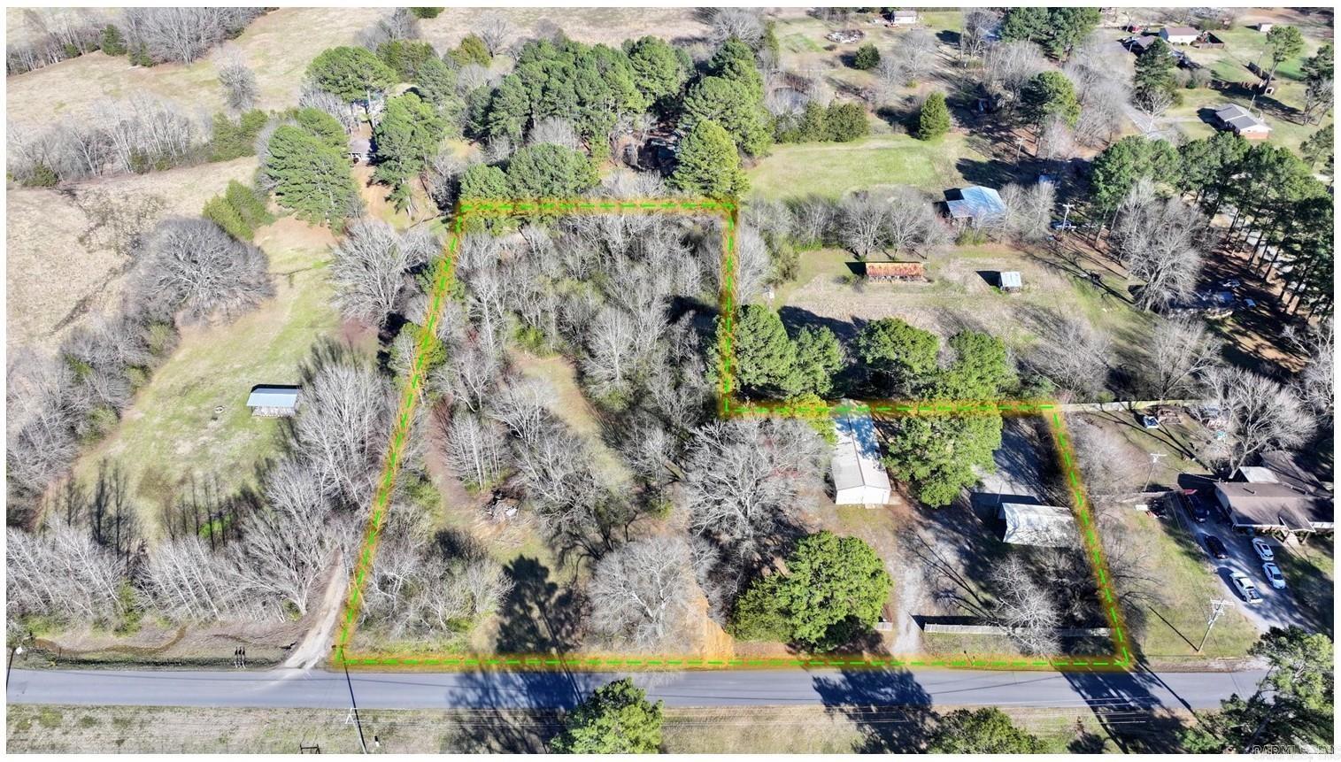 Approximately 3.14 acres with a shop features a spacious shop building situated just outside the city limits. Imagine the possibilities with this much land and the convenience of a large shop right on your property. Metal building with multiple access points, including roll-up doors. Inside, you'll find a concrete floor, ample lighting, built-in shelving, and even a utility sink. This is the perfect setup for hobbies, storage, a home-based business, or whatever your needs may be. Agents see remarks.