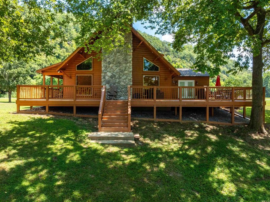 Talk about a VIEW! If you’ve been dreaming of a place with mountain and river views, this one delivers in a big way—right from your wraparound deck! And the best part? It’s just 20 minutes from Batesville.   This home was made for entertaining. The open floor plan keeps everyone connected, and the floor-to-ceiling fireplace and hardwood floors give the living room that warm, welcoming feel.  The primary suite offers a peaceful escape with private deck access, a walk-in closet, and a roomy bath. With three more bedrooms, there’s space for everyone—whether it’s family, guests, or a home office.  Tucked inside a gated community with a community boat launch and Starlink high-speed internet, you get all the perks of a vacation home, with the comfort of a full-time residence. The property is currently used as a second home and vacation rental. Recent updates include a new roof (2024), deck (2024), sealed siding (2024), and new water heater (2025).  Make riverfront living your everyday reality. With unmatched views, direct water access, and a peaceful, private setting, 130 Joe Baker Road is more than a home—it’s a lifestyle.