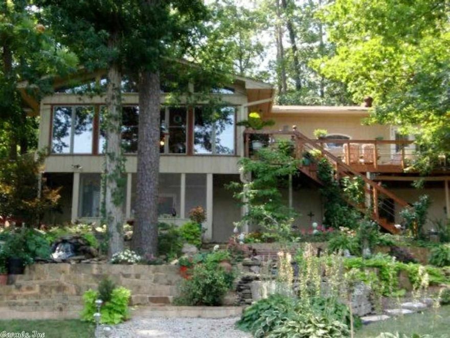 WOW! Best lot on south side of Lake Desoto is professionally landscaped with double level waterfalls, gardens with stone paths, stone park & stone seats all designed to provide year round enjoyment.  Inside this beautifully remodeled home are 3 bedrooms, 3 full baths & 1/2 bath for visitors. Rich Hickory hardwood floors on main level; WB hearth fireplace; and updated kitchen with stainless steel appliances. Owners have obtained Elevation Certificate-No Flood Insurance Required! Continued in Agent Remarks-