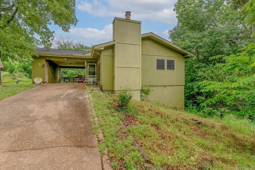 Located in the peaceful Ozark community of Cherokee Village, 7 Cochise Rd offers the perfect blend of charm, space, and potential. This inviting 4-bedroom, 2-bath home features approximately 1,676+ square feet with an open living, kitchen, and dining area designed for comfortable everyday living. A cozy wood-burning fireplace creates a warm gathering space in the retro sunken living room, while the enclosed sun porch and outdoor deck provide the perfect spots to relax and enjoy the natural surroundings.   The walk-out basement adds extra flexibility with an additional bedroom and office area/bedroom, making it ideal for guests, hobbies, or working from home.  New Hvac installed in 2023 along with vinyl plank flooring, furnace in 2022, New Shingled Roof in 2022. Property was inherited and is sold as is Fully Furnished.  Situated in a quiet neighborhood on 2 lots,  one lot could go down to the river with clearing, also close to the lakes, golf courses, and amenities that make Cherokee Village so desirable, this property is perfect as a full-time residence, vacation getaway, or investment opportunity. This custom-built home truly shines.