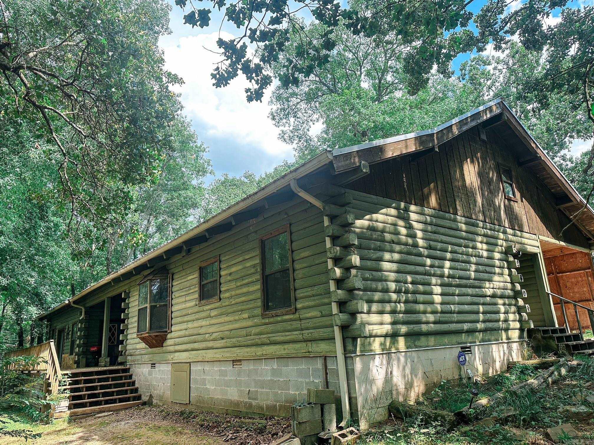 This beautifully updated 3,240 sq ft log cabin offers 3 spacious bedrooms, a bonus room, 1.5 baths, and a perfect blend of rustic charm and modern updates. Enjoy vaulted ceilings with wood beams, a stunning rock fireplace, and a cozy yet open layout. Outside, relax on the large front porch, explore the peaceful pond, or make use of the oversized metal shop. A covered carport adds convenience, and you're just a 5 minute drive from Hwy 67/167āenjoy country living with easy access to town. Recent updates (2018) include all new appliances, metal roof, HVAC, and plumbing. Schedule your showing today! Square footage is approximate-Measuring is encouraged.