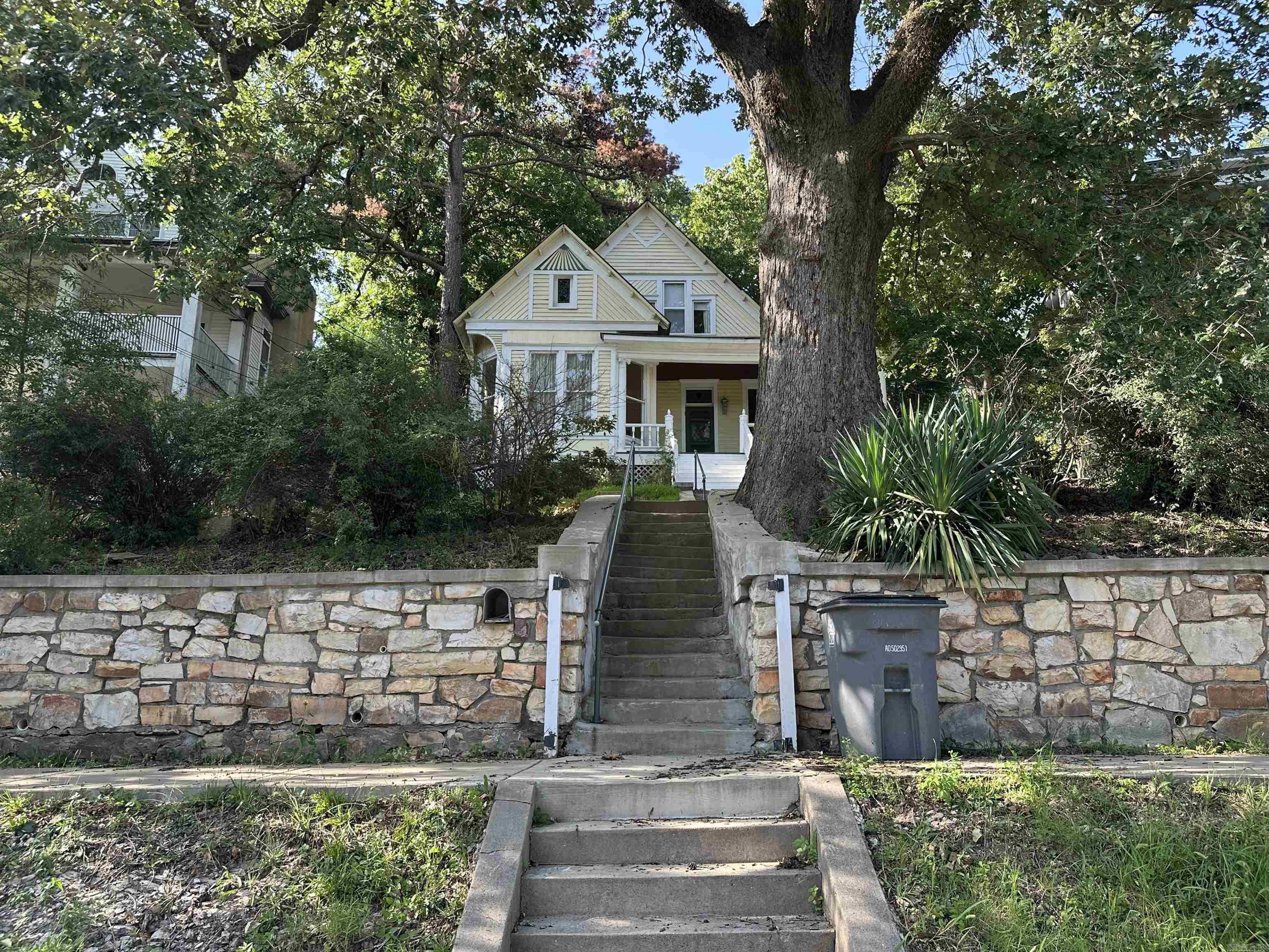 Old World Charm! Built into West Mountains wooded beauty sits this Queen Anne styled home, ready for a transformation. Large gorgeous porch to view Hot Springs National Parks horizon line behind downtown. Established shade trees for nesting birds to listen to while porch sitting. Large living room & separate formal dining room. One bed & bath upstairs and the other bed & bath on the main level. Street parking, which was popular in 1892 when this home was constructed. Own your piece of Hot Springs history and take advantage of the close proximity to Oaklawn Horse Track & Casino, Bathhouse Row and all the downtown shops & dining. Hiking and Northwoods Trail Mountain Bike Trail, Gulpha Gorge, Crystal digging all close by. This home could be a great way to make sweat equity and live in the historic district, enjoying the proximity to all the town has to offer. Great bones and location on this one of a kind property.