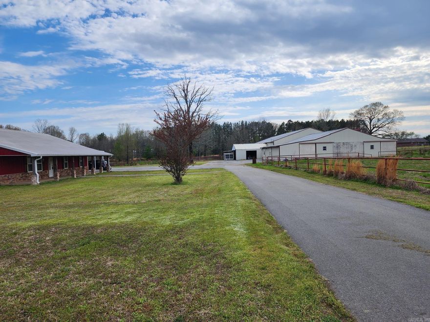 Recently remodeled 5 bed, 3 bath ranch house with 60 x 110 indoor arena & 60 x 80 barn that has 15 indoor stalls & enclosed area of 11,400 Sq ft. The house features wood like tile floors, newer HVAC, metal roof, stainless appliances including refrigerator, dual water heaters, includes 2 sets of washers & dryers, granite countertops, vinyl windows updated in 2017. Recently added double carport, wood privacy fencing with solar power gates, 12 x 24 saferoom, screened in porch, hot tub & paved driveways. 4 turnouts & 18 stalls. Fenced & cross fenced with pipe fencing for separate pastures. This would make a great horse boarding or training facility if you wish to work from home. See agent remarks, appointment only. See agent remarks & survey is in online docs.