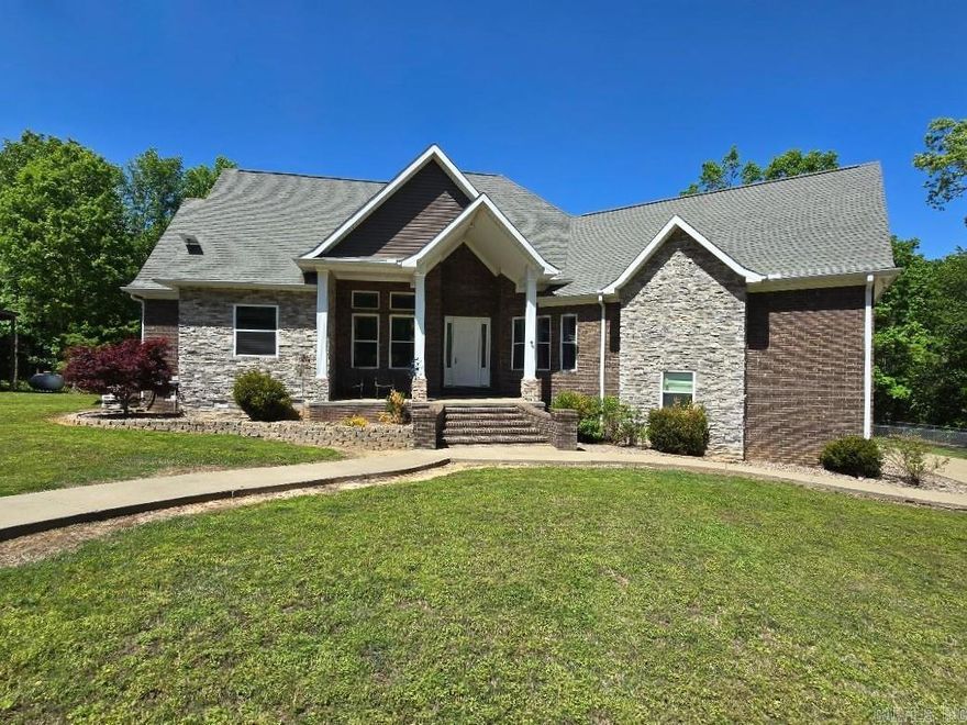 Peace and privacy await! With almost 39 acres, this 3 BR/3BA retreat offers privacy and comfort. First impression, a concrete drive leads to both the home and 40x40 shop. The inviting front porch and huge patio are ideal for outdoor entertaining. The main level offers a spacious great room that includes the living room and a kitchen featuring black shaker-style cabinetry with pull-out storage and granite countertops. A beautiful double-sided fireplace wall offers warmth and visual appeal while connecting the living room and formal dining. The primary suite offers solitude with a generous bedroom, dual vanities, walk-in closet, tub, and a spa-inspired shower complete with a built-in bench and rainfall showerhead. Also on the main level are two more bedrooms, a full bath, and office. Upstairs is a bonus room, a full bath, and walk-in attic access. Outdoors, enjoy a beautifully maintained lawn and pond. A storm shelter & backup generator ensures peace of mind year-round. A pad is ready and there are extra bricks included for a future outdoor kitchen should buyer choose.