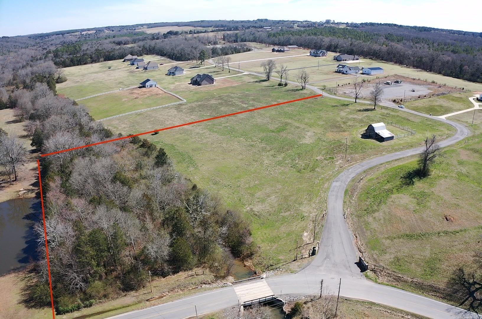 This beautiful 6.82 acre corner lot nestled in Greenbrier's established Brookeview Estates Subdivision is awaiting your dream home. This unique property features a mix of open ready to build on space with a partly wooded area and a creek running through it. The charming barn on the property will allow use for cattle, horses or other recreational use (see covenants and restrictions) 1800 sq. ft. minimum. Utilities available at the road. High Speed Fiber Internet.
