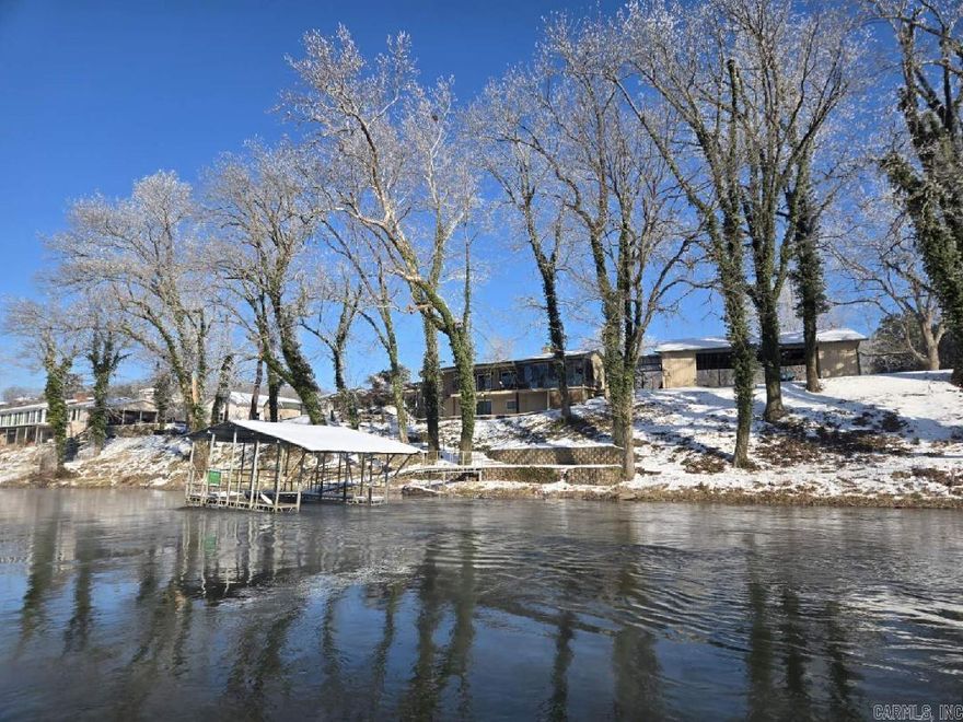 Located in the stunning Arkansas Ozarks on the White River, this property is a dream for pilots and fishermen alike. The 2,428 sq ft home boasts 3 bedrooms and, 2 full baths and sits on 1.44 acres m/l across lots 7, 8, and 9, plus an additional parcel for airstrip access. Store your toys in the 2-car garage/workshop with a 2-slip boat dock. Enjoy 350 feet of riverfrontage and over 1,000 sq ft of hangar space for your plane. Entertain or relax on the 377 sq ft composite/steel deck off the dining room, or the 330 sq ft patio off the primary bedroom. A covered patio connects the home to the oversized detached garage. Parcel #'s 002-09122-000 & 002-10378-000 Offered at $1,250,000.