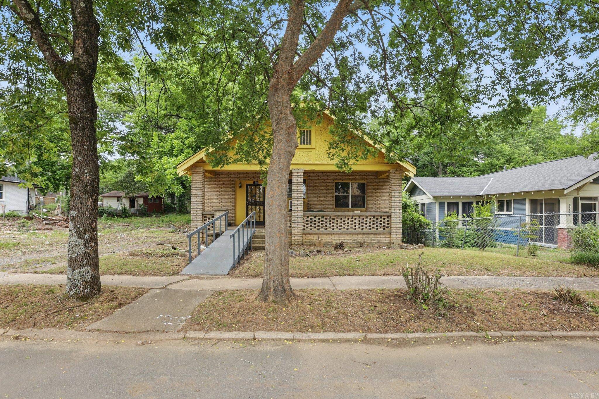 Spacious 4-bedroom, 2-bathroom brick bungalow located across from the nationally recognized Central High School. This property blends classic charm with functional space, featuring original built-in shelving flanking the fireplace, generous natural light, and a welcoming front porch. With its unique architectural details and structure, the home presents opportunity for restoration, personal touches, or long-term investment. Situated in a designated historic district—some updates may require approval. Conveniently located near city amenities, public transit, and cultural landmarks. Please see agent remarks for additional information.