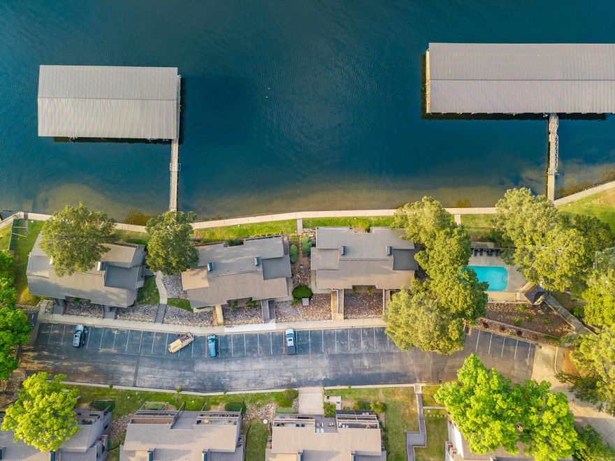 Updated lakefront condo right on the water available just in time for SUMMER! This gated community is convenient to restaurants, shopping, Oaklawn, and all Hot Springs has to offer! Immediately when you walk through the front door, this condo boasts tons of natural light and spectacular wide open water views! The deck spans the width of the unit-perfect for entertaining and taking in the perfect views. Boat slip with new boat lift. Most of Primary bedroom furniture stays with the unit. New HVAC 2023 and Water Heater 2025. This property checks all the boxes for a nightly rental/investment opportunity/vacation OR permanent residence!