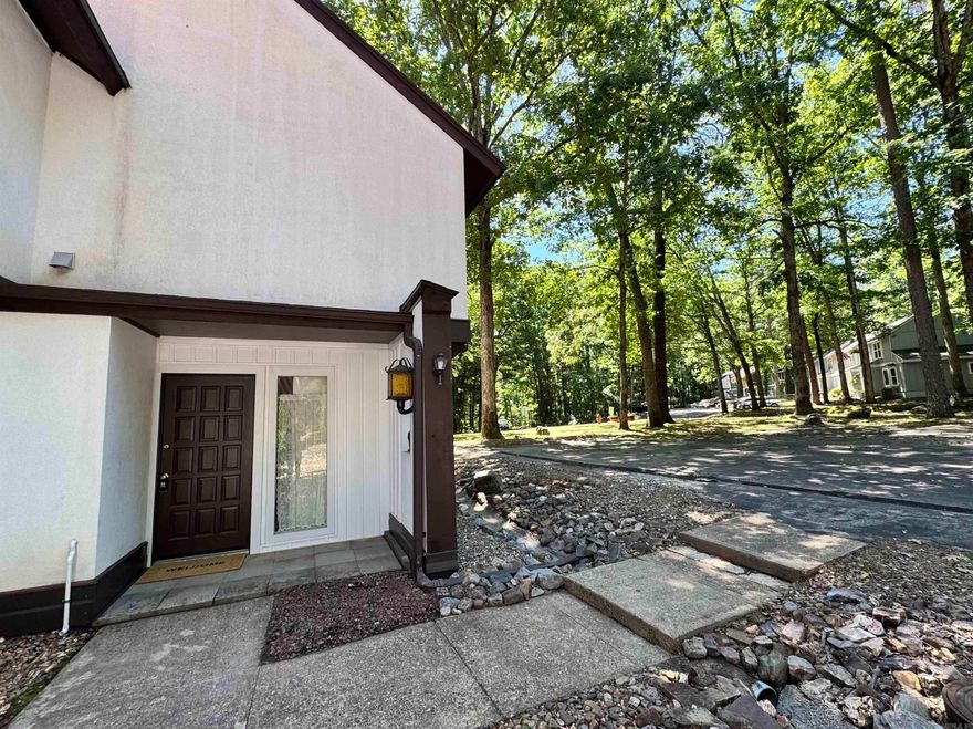 Enjoy golf course views and an unbeatable location near the West Gate on Hwy 7! This beautifully updated townhouse sits directly on the course and is just minutes from shopping, dining, medical services, and recreational facilities.  Recent updates include new carpet, paint, plumbing fixtures, hoses/lines, granite counter tops, and stainless steel appliances. The open living area offers a cozy place to relax with a peaceful golf view.   Hot Springs Village offers 9 golf courses, lakes for boating/fishing, walking trails, tennis, pickleball, playgrounds, and more. Whether you’re looking for relaxation, recreation, or both – it’s all right here. Permanent residents may qualify for the $500 Homestead Exemption—annual taxes around $250!  Don’t miss the opportunity to own this cozy, low-maintenance, and golf view property in one of Arkansas’s most sought-after gated communities. Schedule your private showing today and experience the charm of Hot Springs Village living!