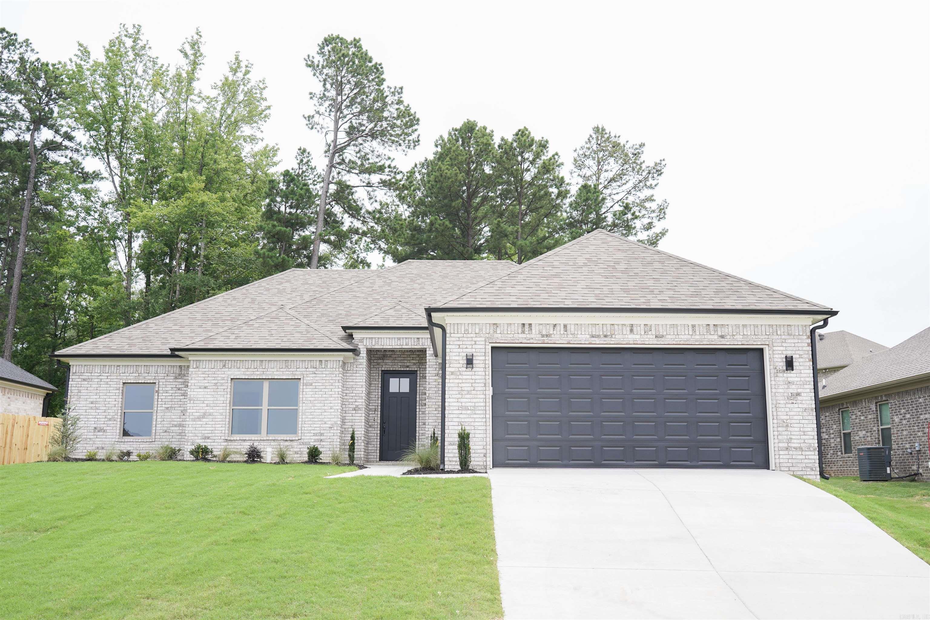 This exquisite new construction home boasts 4 bedrooms & 2 baths, featuring an expansive open concept layout & a sought-after split floor plan. The lavish living room offers ample space for entertainment & relaxation, complete with a sophisticated fireplace that adds a touch of elegance to every gathering. Retreat to the spacious primary suite, where you’ll discover a haven enhanced by an oversized walk-in tile shower & luxurious double vanities for added convenience. The gourmet kitchen is a culinary masterpiece, showcasing a stunning stain-grade accent island, upgraded appliance package, & under cabinet lighting that illuminates the space with style. Throughout the home, you’ll be captivated by the allure of SPC flooring - an upgrade from LVP, designer light fixtures, & generously proportioned spare bedrooms. Spare bath complete with a full shower/tub combo! Step outside to the covered porch & immerse yourself in the tranquility of the surroundings in the fenced backyard. Prepare to be amazed by this must-see home that epitomizes modern living. Don't miss out on this one!