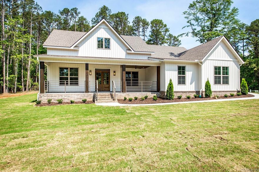 This new construction home in Grand Isle Subdivision, Fairfield Bay Arkansas is an absolute dream come true. Boasting 4185 sq foot of total living space, with 2187 sq ft on the main level  432 sq ft bonus room & bath upstairs, this home has all the features you could imagine. Step out onto the oversized front porch and enjoy that morning coffee.  Enjoy the cool nights with a wood-burning, gas-ignited brick outdoor fireplace on the 432 sq ft rear porch. The level lot of .70 acre has a 3 car garage of 750 sq ft. The interior is nothing short of luxurious, with custom showers, double sink vanity and tub with tile surround and niche in the guest bath, stained tongue & groove ceiling in the kitchen, vaulted ceiling in the great room with 42 inch propane fireplace, tankless water heater, foam insulation and luxury vinyl plank flooring. Custom quartz counter tops throughout, including the butler's pantry, and custom soft close doors & drawers grace the interior. Boating enthusiasts will love having access to a boat slip in Forgotten Peninsula at an additional cost. Fairfield Bay offers 2-18 hole golf courses, 3 swimming pools, tennis, bowling, & hiking/biking trails.