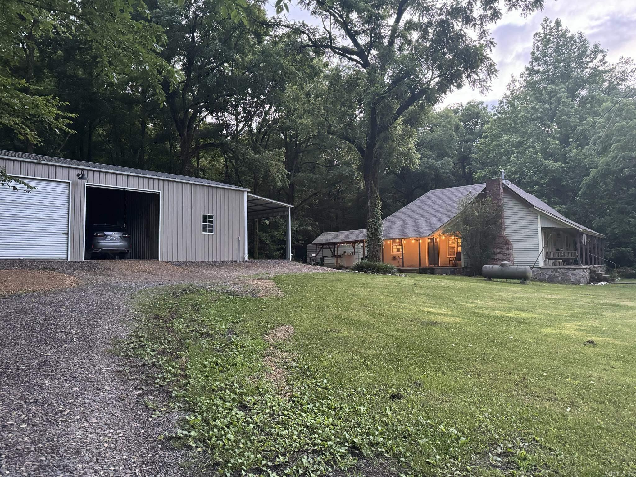 **Adjoining National Forest on Two Sides!** Highly Sought after property! Discover this charming homestead built in 1900's 2-bedroom home on 6.63 acres, offering abundant amenities. Recently updated with new flooring, a new roof, and a water heater, this home also boasts two walk-in closets and a convenient laundry area. There is flexible space for an office or workout room, allowing you to tailor it to your needs. Additionally, the property includes a large two-car garage with a living area and a half bath, complete with plumbing for a shower. A shed and other outbuildings provide extra storage. Lots of wildlife, deer, turkey, rabbits, squirrel, and more! Located near the Wolf Pen Gap Trails (you can leave the property on your side by side/4 wheeler and go straight to the trails) and a year-round creek, this property is a must-see. Don't miss outācall today to schedule your showing! Mineral rights do not convey, previously reserved. Home Warranty offered