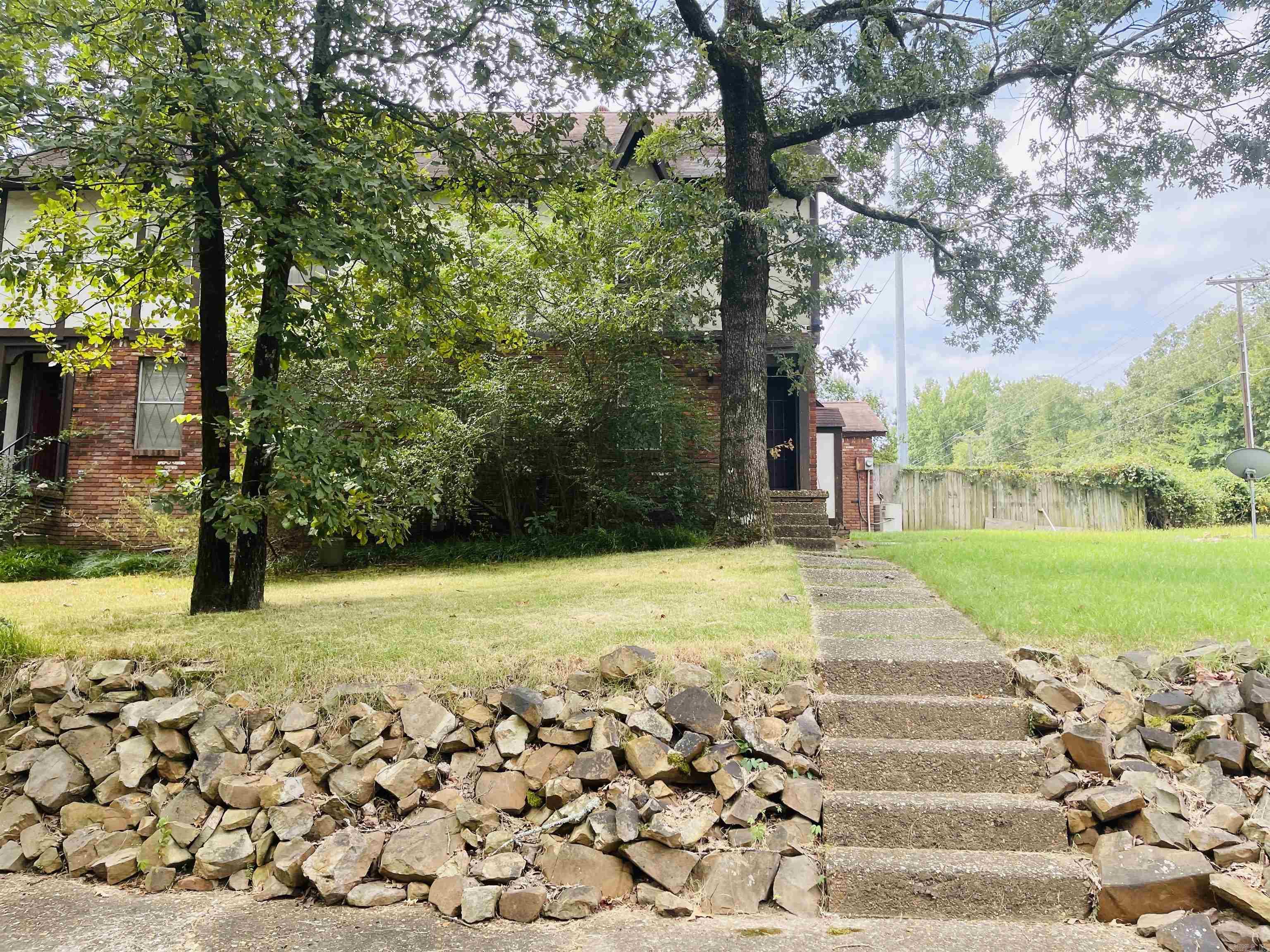 Discover the perfect blend of comfort and convenience at 55 Falling Creek Dr, North Little Rock! This charming townhouse boasts 3 spacious bedrooms and 2 well-appointed bathrooms, offering 1,426 sq. ft. of living space ideal for families, first-time buyers, or savvy investors looking to expand their portfolio. Built in 1975 with a durable combo brick frame and a cozy gas fireplace, this home invites warmth and style. Situated just moments from Pulaski Technical College, your commute is a breeze! Embrace vibrant living with the nearby Argentina Arts District, teeming with creativity and local delights. Plus, the Simmons Bank Arena is just a short drive away, making it easy to enjoy exhilarating concerts and events. This property is being sold AS IS, presenting a unique opportunity for customization and investment. Don’t miss out on this fantastic chance to own in a sought-after location—make it yours today!