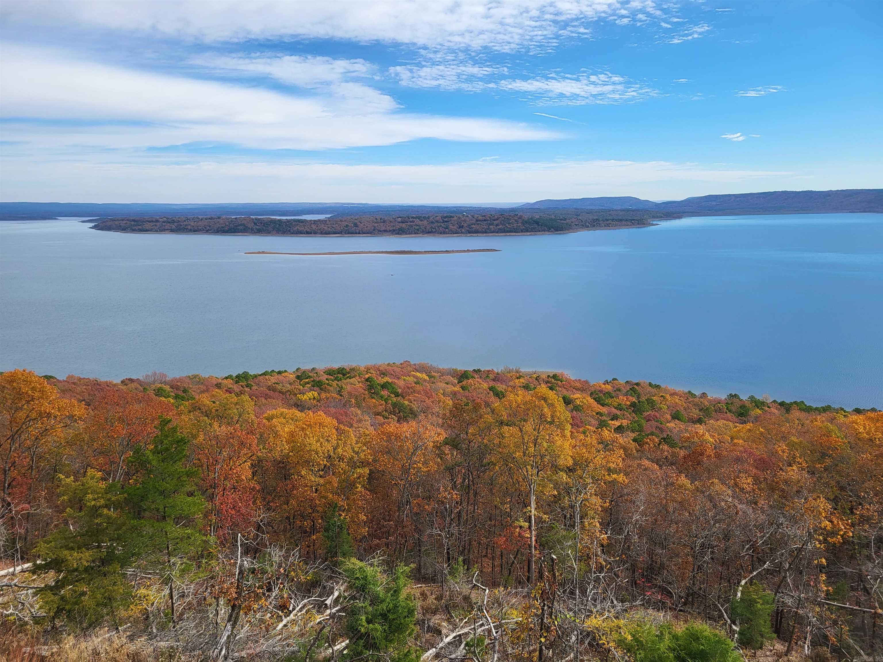 Fabulous lake frontage of 139.93 feet with spectacular views on high bluff. Many large trees. Adjacent Tract #20 available. Deed restrictions. Seller financing of 10% down, 20 years at 8%. Detailed brochure. Paved county road. Fiber optic cable internet. Public water, electric, phone, septic. All proceeds go to a Charitable Trust. This is the 2nd best tract on beautiful Greers Ferry Lake! See drone video attached and other videos plus photos. For more details , see our website.