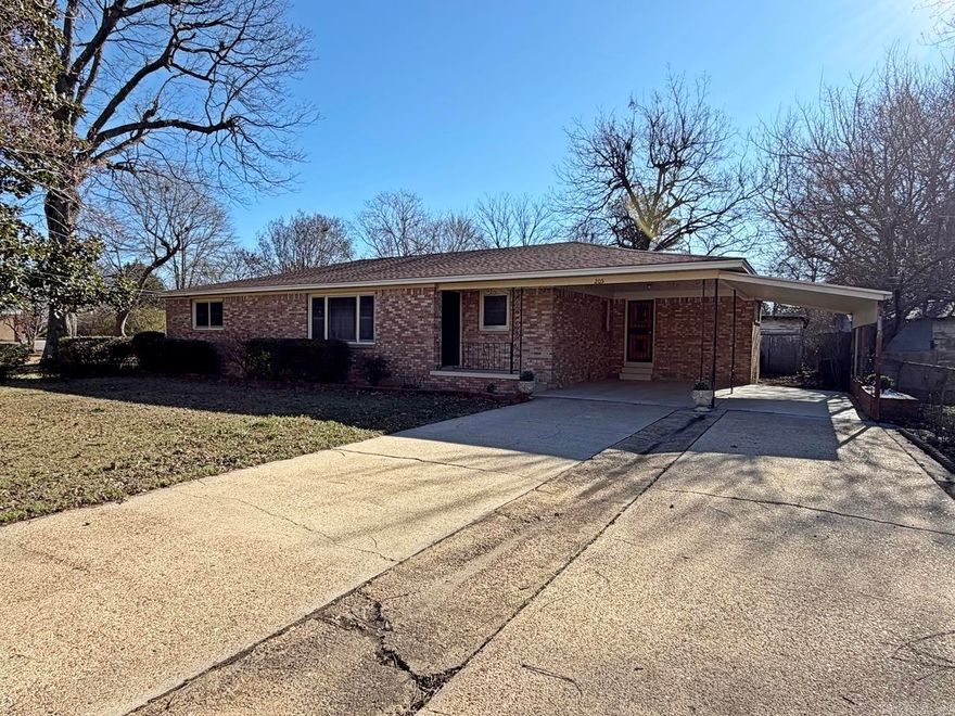 This charming 1960's mid-century modern all-brick ranch home is in pristine condition and built with excellent craftmanship. Much of the original charm has remained and has been lovingly cared for. It has a very roomy and efficient layout which offers a generous living area and dining room combination, a nice eat-in kitchen with well-crafted cabinets, a oversized laundry room, private dedicated office, three bedrooms, and two full baths. Some walls are clad in hardwood paneling. Beautiful hardwood floors are throughout most of the home, with newer tile floors in the kitchen and laundry, vintage tile in the bathrooms, and carpet in one bedroom. Recent updates included newer heat and air, and new architectural shingled roof in 2023, providing comfort and peace of mind for years to come. Situated on a large lot, this home features a 20' x 25' shop building with a roll-up overhead door perfect for hobbies, projects, or extra storage. A two-car carport is located on the side of the home. Don't miss out on this well built charmer!