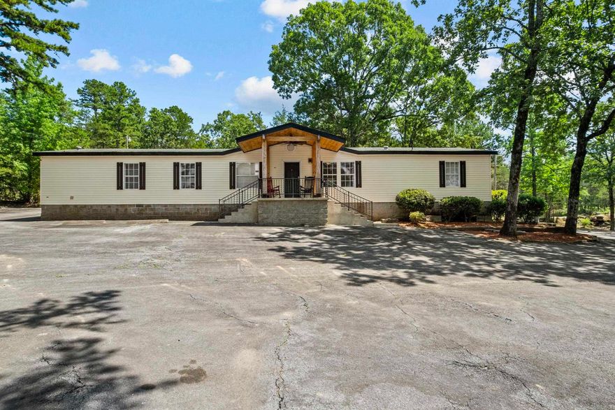 Welcome to 15 Industrial Park! This updated 3-bedroom, 1.5 bath mobile home sits on a permanent foundation and offers 1,950 sq ft of comfortable commercial or living space on an approximate 1.75-acre lot. Direct views of Sugarloaf mountain can be seen from many angles on the property! Recently refreshed with new flooring, paint, countertops, and more, this space is move-in ready. Featuring plenty of parking spaces and a flexible layout that makes this property perfect as a primary residence, rental investment, or a prime commercial opportunity. Located at the high-visibility corner of Wilburn Road and AR Highway 210, the location offers fantastic exposure for a business or unbeatable convenience for homeowners.