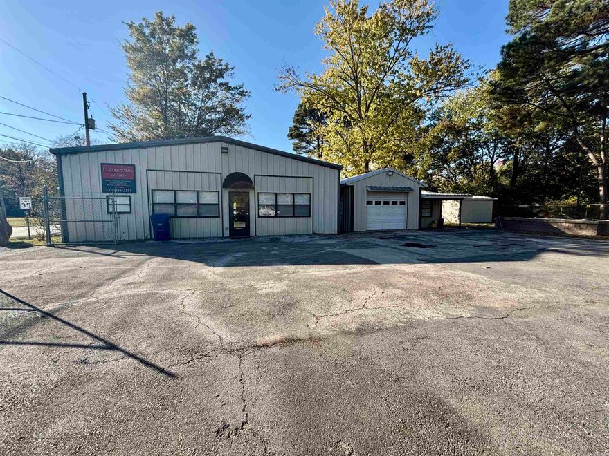 This property has endless possibilities.  It was recently used as a beauty and gift shop.  There is a kitchen, two office areas, two bathrooms, garage area, two separate 10 x 10 rooms that have been used for tanning areas, and the large open area that was used as the beauty shop.  You have the option to open the front of the building up as two garage bays.  The tanning bed, kitchen appliances, all beauty shop chairs, sinks, etc. as well as the 80 gallon air compressor will stay with the right offer.  You don't want to miss out on this great building that sits on a busy corner lot with easy access to the highway.  Not to mention the property has a fence around it.