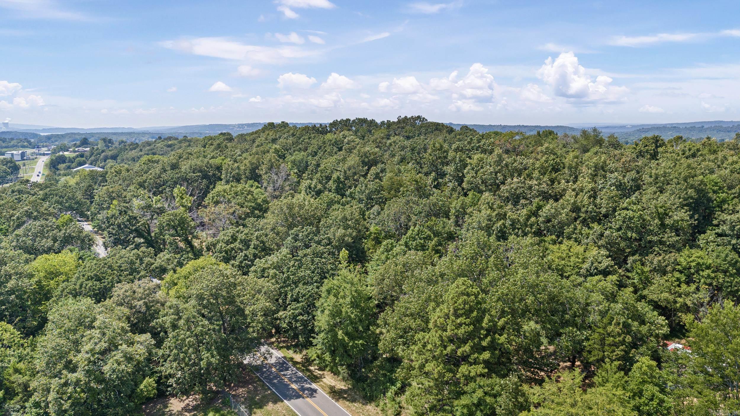 This approximately 7-8 acre parcel, located just north of the interstate offers a prime development opportunity for residential or commercial projects. The property is easily accessible, with power and water available at the street, simplifying the development process. Its gently sloping topography provides both aesthetic appeal and practical advantages, ideal for tiered housing or a unique commercial layout. With its strategic location and versatile potential, this land is the perfect canvas for your next visionary project!