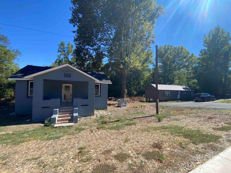 This property is prime with 320' of Hwy frontage located just outside Hot Springs City limits on Hwy 7 North. The paved highway frontage is 4-lane with easy access to any part of the property. The home on the property has a new roof, new windows, and new exterior paint. The interior has been gutted and ready for reconstruction. An 18'x50' tiny home has been placed on the property ready to be finished out.  There is also plenty of room left to add more tiny homes with over 300' of creek frontage and great access to Hot Spring or Hot Springs Village. This would be a great place to start your nightly rental haven or any other business.
