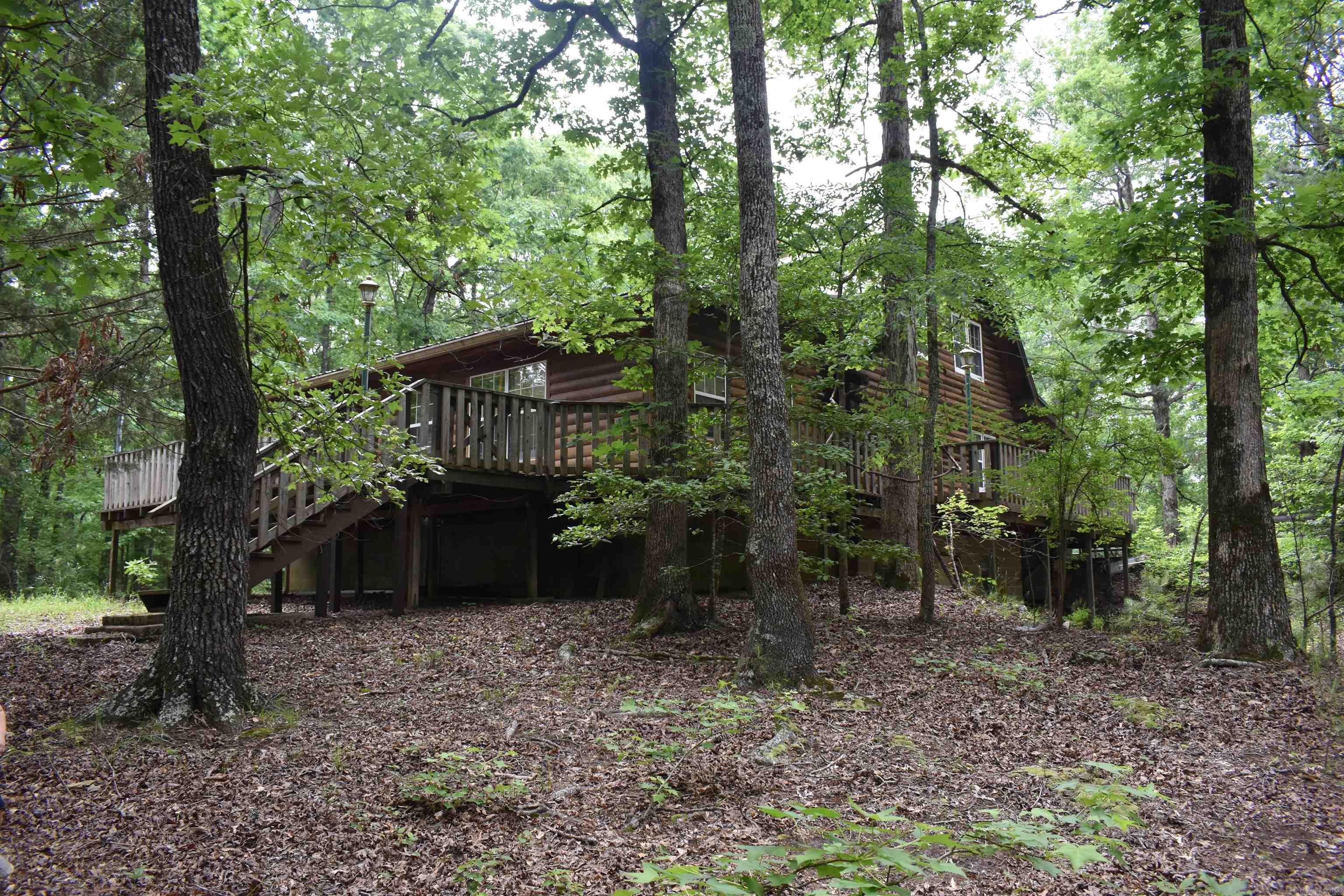 Tucked into a grove of mature hardwood timber, this real log home on 70 +/- acres has many great features. The 2864 +/- Square foot home boasts three beds and two baths, porches, decks, and outdoor storage areas. Being located just down the road from the Caddo River, and adjoining the Ouachita National Forest, this acreage is an outdoorsmanās dream and in a perfect location. ⢠2864 +/- Square Foot Real Log Home ⢠3 beds 2 baths ⢠70 +/- Acres ⢠Ouachita National Forest Boundary ⢠Minutes from the Caddo River ⢠Detached two car garage ⢠Multiple storage buildings ⢠Walk out basement ⢠Wood stove ⢠Porches and Decks on three sides ⢠Mature timber ⢠Great Views ⢠Excellent Deer and Turkey hunting ⢠Good Topography ⢠Private and Secluded ⢠20 Minutes from Glenwood ⢠15 Minutes to Caddo Gap