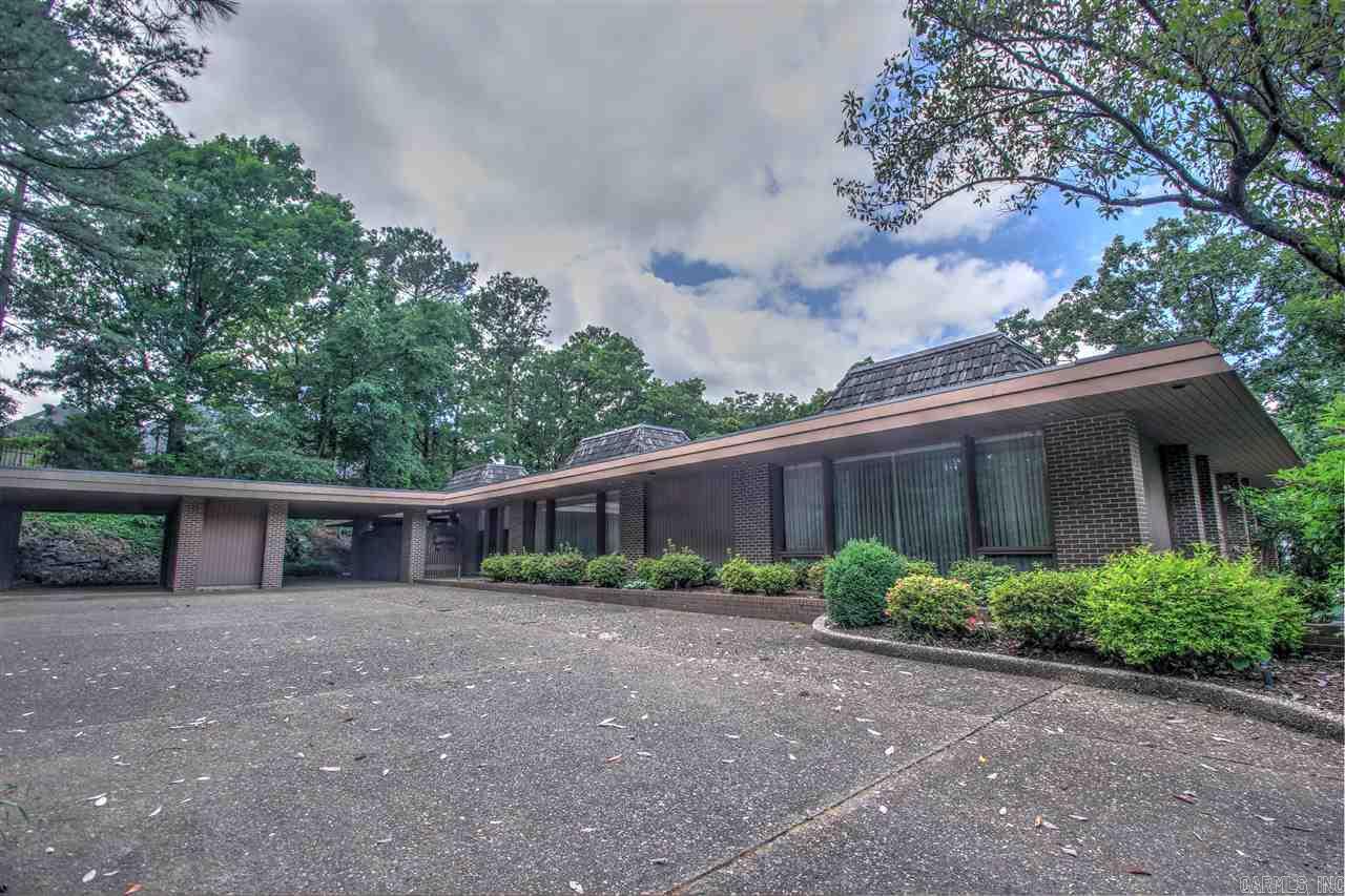Resounding tribute to mid-century modern with a home designed by Arkansas’ architect Noland Blass. This one-of-a-kind, hidden treasure is on a secluded point with beautiful unmatched river views. You’ll notice the attention to detail, superior construction. Spaces include 2 living areas a private large pool area that can accommodate events. Estate property to be sold as is. Great opportunity for an investor. With the right updates this will be a fabulous property. AGENT MUST OPEN
