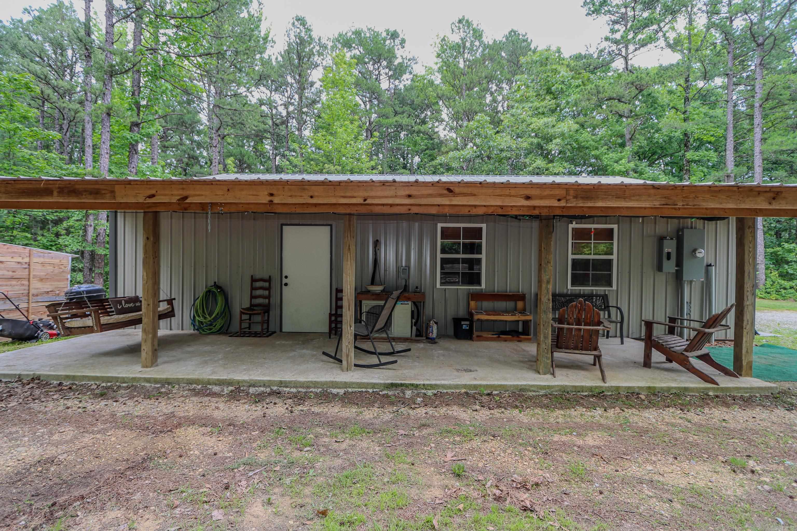 Secluded, Peaceful and Serene best describes this 1200 sq ft shop house sitting on 20 acres with mature trees, rolling hills, trails for ATV's and PRIME hunting ground with the pictures to prove it! The 2 bedroom and 1 bath home features an open floor plan with insulated overhead door that would be perfect to open on those cool fall nights and enjoy the weather. Storage shed out back to hold supplies and there is a covered porch with a swing to soak up the outdoors!