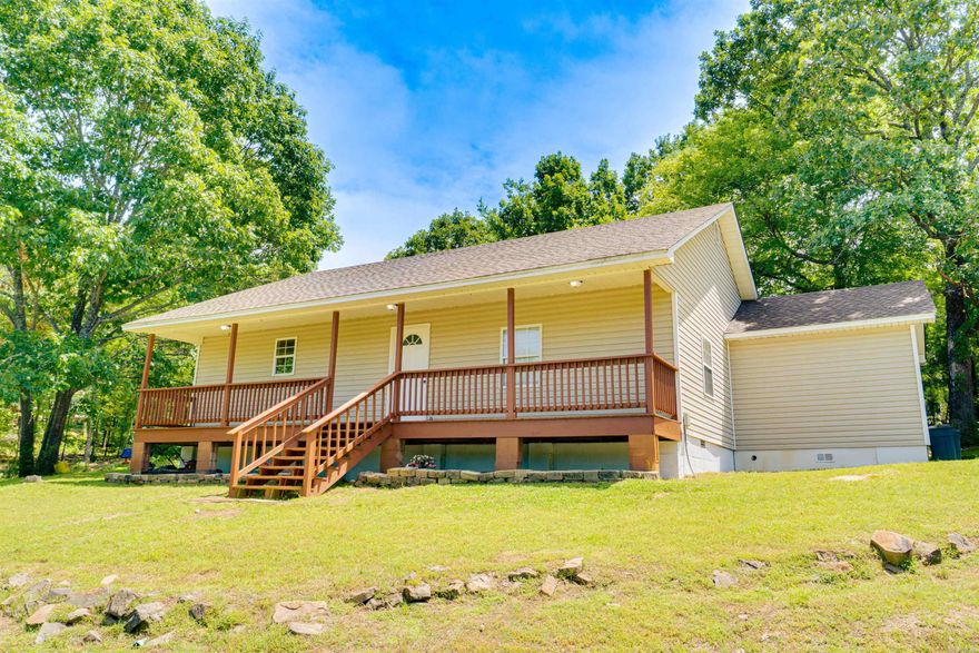 Tucked into the hillside just 5 minutes from Perryville and 20 minutes from Conway, this charming 3-bedroom, 2-bath home offers the perfect blend of peaceful country living and modern convenience. The open-concept layout makes the home feel spacious and highly functional. The large living room flows seamlessly into the kitchen, which features a new stove and new refrigerator, a breakfast bar, abundant counter space, and real wood cabinetry. Step outside to a cozy front porch stretching the full length of the house- the perfect place for relaxing and taking in the hilltop views and peaceful surroundings. The property also includes a water well and a basketball court on a concrete slab, offering endless possibilities for recreation, entertaining, or easy conversion into a shop or storage building. Additional updates include a brand-new architectural shingle roof installed 5/26, and a new washer and dryer that conveys as well. It can also be purchased fully furnished for an additional cost. The homes excellent condition qualifies it for FHA, VA, and USDA-RD financing, including no-money-down options! Agents, please see remarks for scheduling notes.