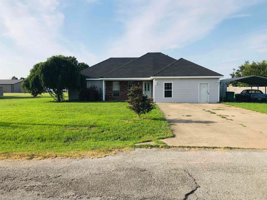 Cute 3 bedroom, 2 bath home in quiet subdivision on the westside of Trumann, Arkansas, near schools and shopping, with easy access to I-555 and within 15 -20 minute drive of Jonesboro! Situated on .67 acres, this home has lots of possibilities with space enough to construct a large shed and/or plant a good sized garden. The front door opens to the living room which has laminate flooring. To the left are two guest bedrooms and a full bath, while to the right is a very nice laundry room and master bedroom en-suite. The current owners have recently enclosed the two car garage to provide the possibility of a second living space/bonus room. The eat-in kitchen has a good amount of cabinets, with a built-in microwave above the range. The refrigerator in the kitchen will convey with the property, The dining area of the kitchen opens to the north side of the house and onto a back porch that is an ample size, with a nice view of the backyard. While there is no attached garage, there is, however a detached, portable metal carport that will also convey with the property. A new HVAC unit was installed approximately and a new roof was installed in 2016.