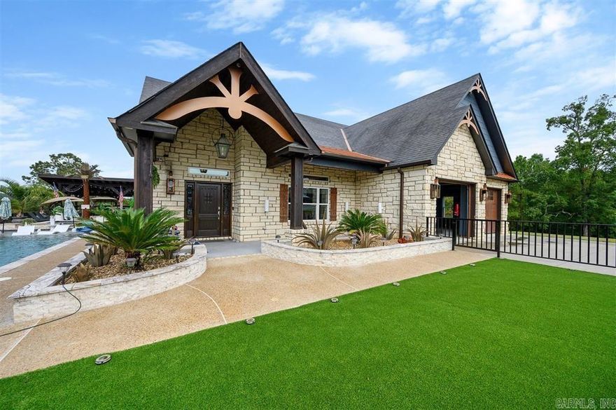 Luxury estate on 40+ acres in DeQueen, AR offering privacy, space, and upscale living. This 5 bedroom, 4 bath home features a split-bedroom layout, including a versatile bunk room, and a primary suite with direct access to the outdoor living area. Upstairs offers an oversized media room with full bar, game room, and two additional bedrooms. The gourmet kitchen is equipped with Wolf appliances, custom cabinetry, granite countertops, and a double oven. Outdoor amenities include an infinity and lap pool, jacuzzi, outdoor kitchen, fireplace, and fire pit—perfect for entertaining. The property also features a large pond and is bordered by Corps of Engineer land on three sides for added privacy. Additional improvements include two shops (over 5,000 sq ft with bathroom and 1,800 sq ft) and a horse barn with stalls. Conveniently located just 35 minutes from Hochatown and Broken Bow Lake.