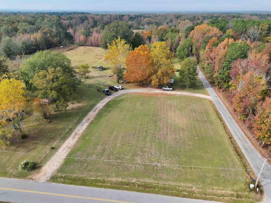 Charming country home on 15.48 acres! Enjoy peaceful rural living on this 15.48-acre property featuring cleared pasture land, a pond, and a creek that add to the serene setting. The fields are divided into three but all connect.  The first field is the backyard, the other two follow but both have gated road entries - Perfect for livestock! Includes a barn that could be restored! Includes a circle drive and a spacious front yard, as well as a portable one-car carport for covered parking. Located in a beautiful rural area just 15 minutes outside the city of Sheridan, this property offers the ideal blend of country charm and convenience-ready for your personal touch of small farm dreams!  3 Bedroom, 2 Full-baths and a very cozy living area! The range, refrigerator, and microwave all stay!