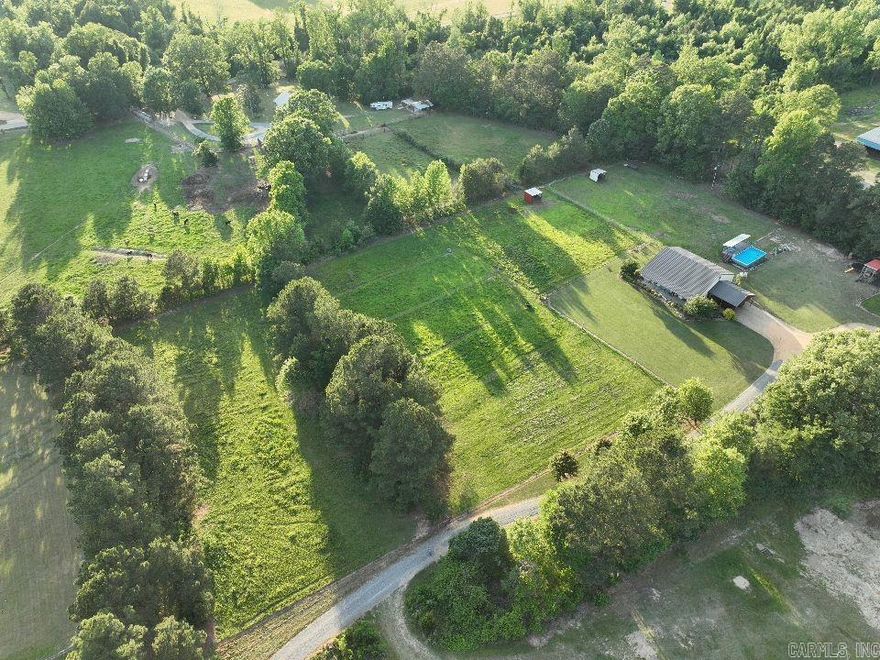 Sitting on 6 well-maintained acres, this red iron barndominium was built with durability, efficiency, and everyday living in mind. The home features a custom interior with wood siding and a one-of-a-kind iron staircase. The downstairs layout is open and practical, with the master suite on the main level, complete with a X-large walk-in closet, office space, and easy access to one of two laundry areas.  Upstairs, you’ll find two large bedrooms, each with its own private loft area that works well for studying, relaxing, or extra storage. There’s also a full bathroom and a wideopen space that can be used for entertainment, a second living area, or a place for the kids to hang out. The home is built with 6-inch spray foam and closed cell in the ceiling, making it efficient and easy to heat and cool year-round. Outside, the setup is ready for both work and recreation. A breezeway runs the full length of the home, connecting to two horse stalls with water and electricity already in place. The property is set up for rotational grazing with multiple fenced paddocks, all tied together with high-output electric fencing.