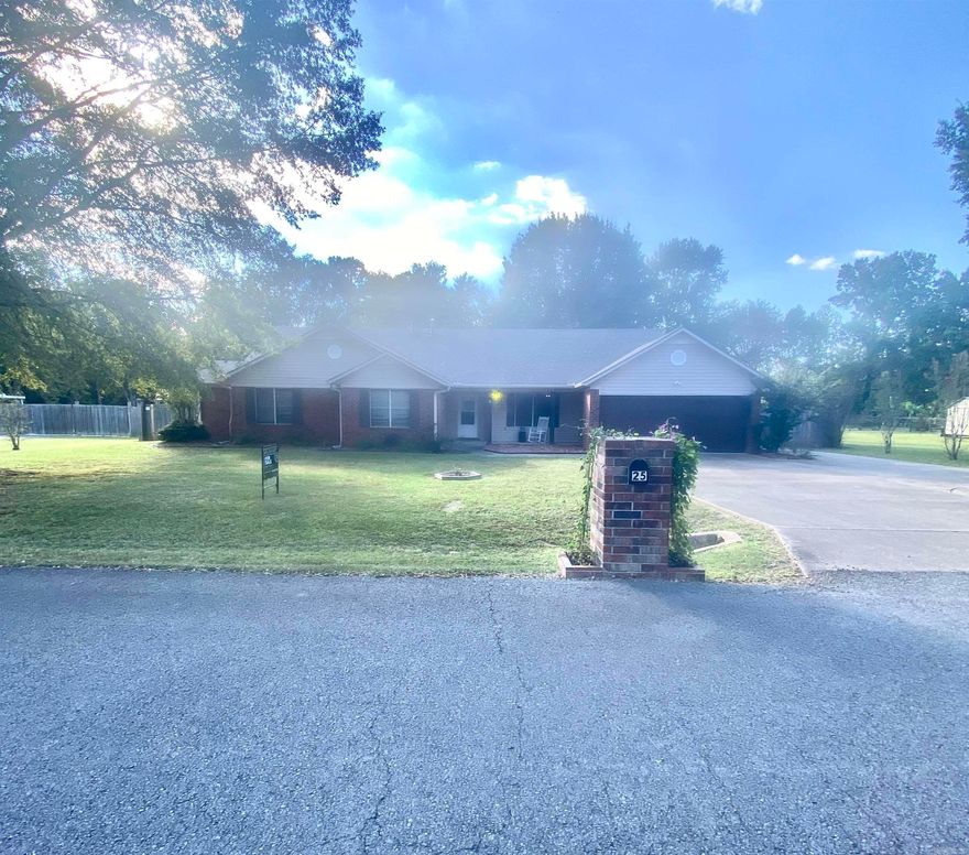 Beautifully maintained home with fantastic features inside and out! The property offers a large, pre-plumbed shop with 210 power, ideal for projects or extra storage, plus a separate storage building and extra parking pad. The fenced yard extends beyond the back fence into a wooded area, with double gates at both the front and back for easy access. The home is also set up for a generator, adding peace of mind. Enjoy outdoor living with a welcoming front porch and a covered back deck perfect for relaxing or entertaining. Inside, the home features a cozy fireplace, a bright bay window in the eat-in kitchen, and a bonus room (not included in the bedroom count) for flexible use. Two bedrooms have attached full baths, offering extra comfort and privacy. Additional highlights include a separate storm shelter and the option to purchase all furniture. Located in a quiet, friendly neighborhood, this clean, well-cared-for property is ready to be your next home.