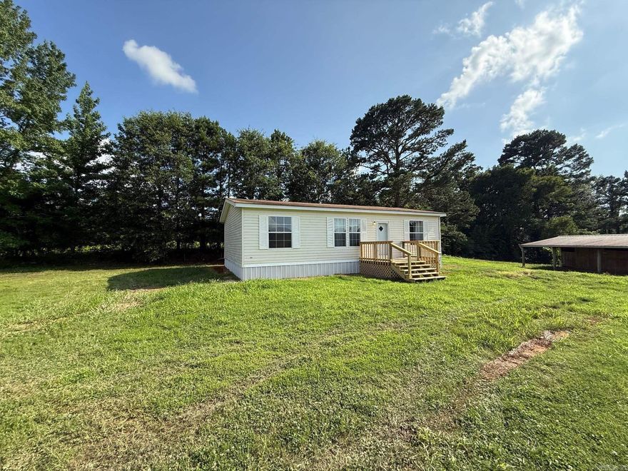 This beautiful 1+ acre property is the perfect setting for a small farm or peaceful country living. Thoughtfully maintained and move-in ready, it includes a 3-stall metal horse barn or future outdoor kitchen with storage compartments, a pond, and a spacious manufactured home set on a permanent foundation. Enjoy country living relaxing on the new decks in the front and back and just a few miles from Lake DeGray. Also comes with a new outside heat/ac unit.   The home features 3 bedrooms, 2 full bathrooms, a laundry room, and an open-concept living room and kitchen all in a well-cared-for, fully functional layout. Property may qualify for certain lenders VA Hometown Program.  Located in the desirable Bismarck School District, the property enjoys convenient access to surrounding towns via a main thoroughfare, making rural living easily connected to city amenities.  An added bonus: the property has already passed a perc test for a second homesite, making it ready for a future 2-bedroom, 2-bath home — ideal for extended family, guests, or investment potential.  This one-of-a-kind property offers endless possibilities.