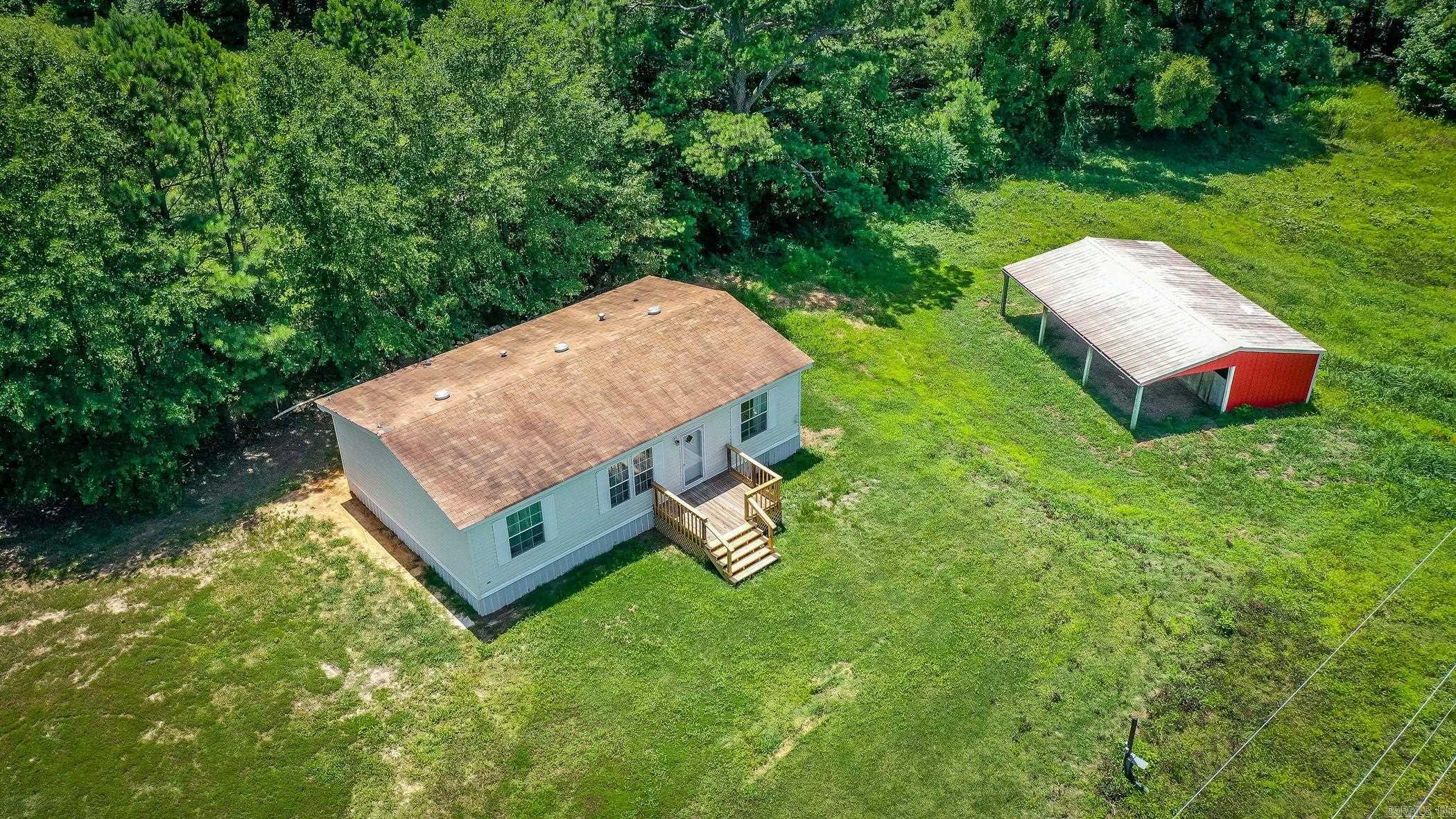 This beautiful 1+ acre property is the perfect setting for a small farm or peaceful country living. Thoughtfully maintained and move-in ready, it includes a 3-stall metal horse barn or future outdoor kitchen with storage compartments, a pond, and a spacious manufactured home set on a permanent foundation. Enjoy country living relaxing on the new decks in the front and back and just a few miles from Lake DeGray. Also comes with a new outside heat/ac unit. The home features 3 bedrooms, 2 full bathrooms, a laundry room, and an open-concept living room and kitchen all in a well-cared-for, fully functional layout that offers both comfort and practicality. Seller is offering $3000 in seller paid closing costs. Located in the desirable Bismarck School District, the property enjoys convenient access to surrounding towns via a main thoroughfare, making rural living easily connected to city amenities. An added bonus: the property has already passed a perc test for a second homesite, making it ready for a future 2-bedroom, 2-bath home ā ideal for extended family, guests, or investment potential. This one-of-a-kind property offers endless possibilities. Schedule your showing today!