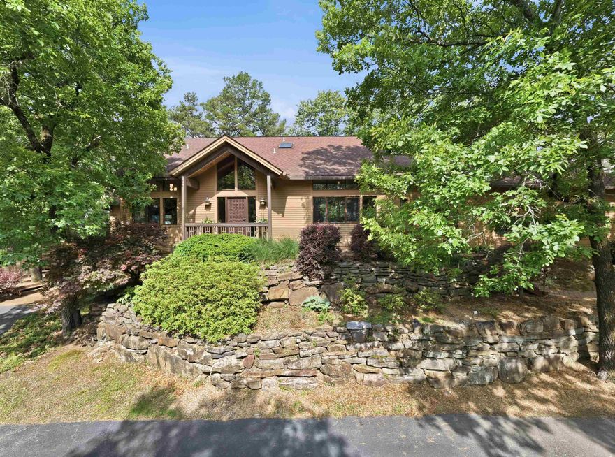 Nestled along the shoreline of Greers Ferry Lake, this stunning lakefront retreat embodies timeless elegance and a serene lake view. Thoughtfully crafted with mahogany beams enduring style, the home features spacious living areas filled with natural light, soaring ceilings and expansive windows. The main living areas offer a warm yet elegant ambiance, while the well-appointed kitchen provides beauty and function for gathering with family and guests. The fully finished basement expands the living space, offering endless possibilities for recreation, in-law quarters, hosting or a private getaway within the home. CLOSET SPACE galore. Office is complete with built ins.  This home also includes a detached 2 car garage for all types of storage. This home is a must see!! Call today for your private showing!