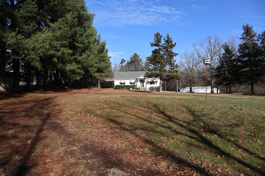 IN TOWN HOME, SHOP & ACREAGE WITH DEVELOPMENT POTENTIAL  Property located at 533 North St, Salem, AR. This 4 bdr. , 1.5 bath has approx. 2,356 sq. ft. of living area. Also includes large carport and a partial unfinished basement. It has range, oven, dishwasher, gas heater, wall electric heater and window A/C units. Hardwood and carpet flooring. Spacious family room. The home is an older home and will need some upgrades. It has a park like setting. Also include a large 3 bay shop building, 2 storage buildings, propane tank and dog pen. The home sits on over 9 acres in the center of Salem. Great location, close to shopping, post office, schools and hospital. This property is gently rolling, has a pond and has great potential for development with the acreage available. Lake Norfork, Spring River & the world famous White River are 30-45 minutes away. Real estate taxes last year were $1,301.72.