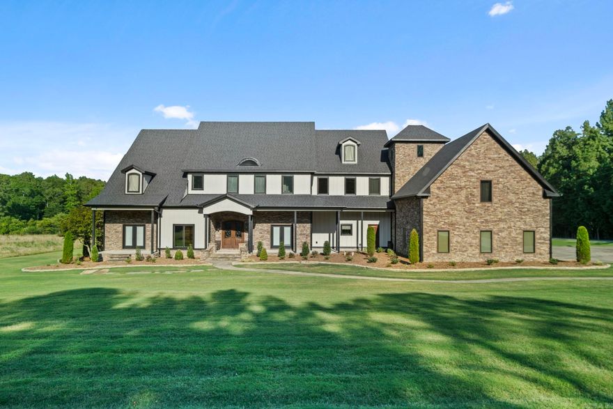 Discover this fantastic home set on 7.15 acres, meticulously maintained and perfect for those seeking comfort and style. The main level boasts 14' ceilings and concrete floors throughout, adding to its modern appeal. Recent updates include a new roof, concrete board siding, gutters, exterior LED lights, a fireplace, and fresh exterior paint.  This home is equipped with a Control4 automated system, heated flooring in the main bathroom, a FEMA-approved safe room, and a whole-home generator, ensuring convenience, safety, and comfort. Ideal for horse lovers, the property allows for horses, and the shop features 2 stalls. Don’t miss the chance to see this stunning property!