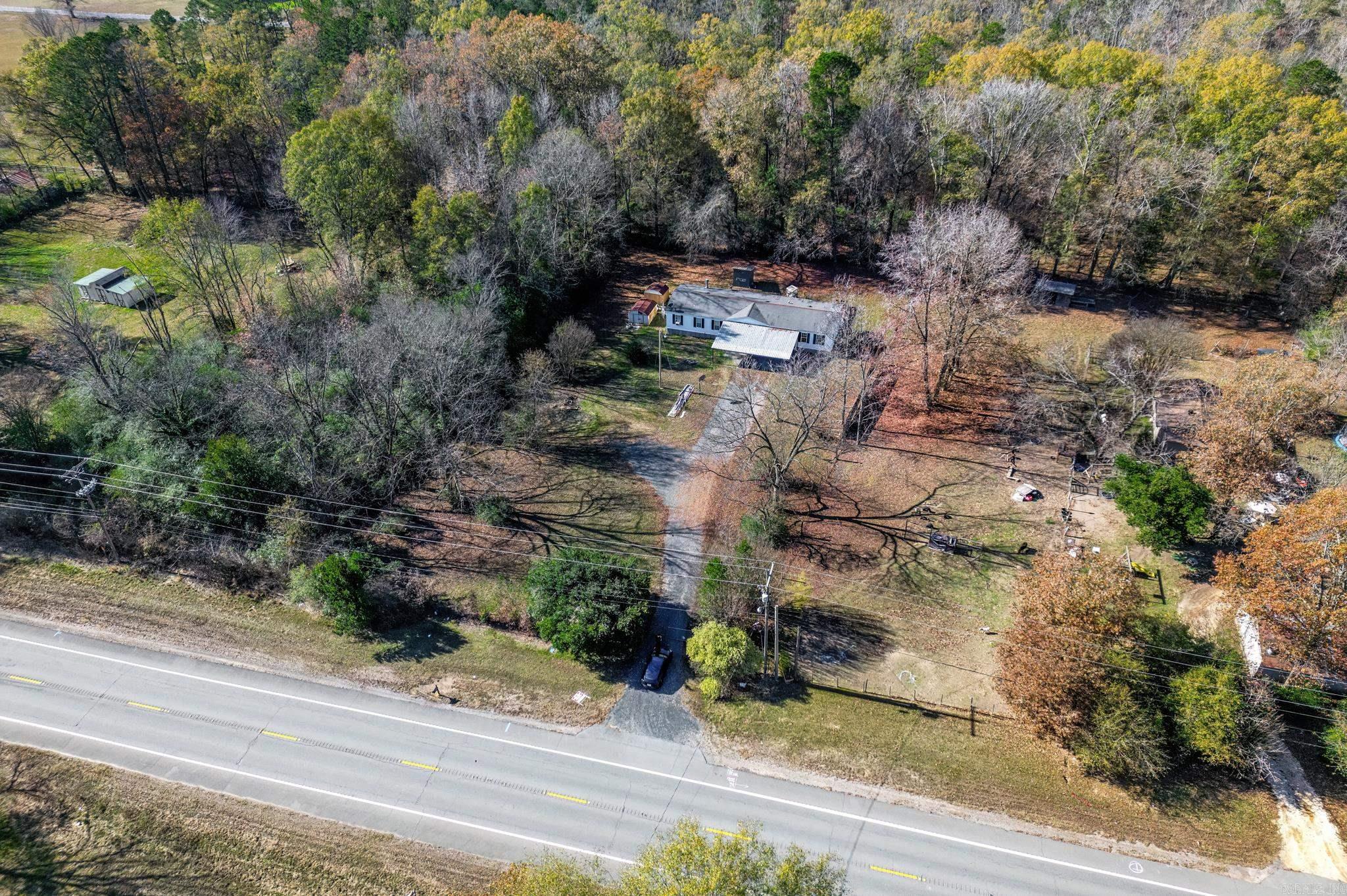 Beautiful mature trees surround this .98 acre property situated on Hwy 67, just minutes from the Glen Rose Schools. In addition to the 2128 sqft updated manufactured home, there is a 2nd septic tank at the front of the property that could easily accommodate another home for multiple families or extra income or a shop for a business. The property is fully fenced, gated and has an inground storm shelter, lean to carport for 4 or more vehicles and an asphalt driveway w/ turnaround. The interior of the home is VERY spacious with updates throughout and boasts a split floor plan with 2 living areas, a fireplace, and a large kitchen with tons of storage. The primary suite features a beautifully built custom gun cabinet (with extra storage for all your ammo and accessories) and a large bathroom with shower, Jacuzzi tub, and his/her closets. The primary suite also has a custom built in room that could be used as a 5th bedroom, nursery, office or craft room! *High Speed Fiber Optic Internet provided by South Central Connect coming soon* Call an agent to schedule a showing.