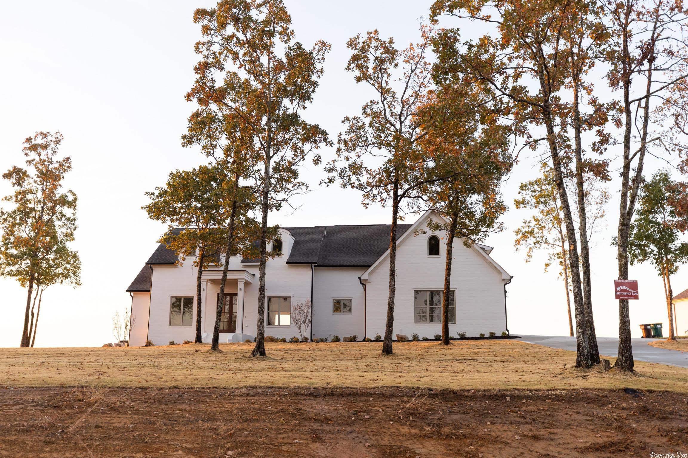 Painted brick exterior. Interior features 3 bedrooms and 3 bathrooms with a spacious living room, kitchen, and dining area that highlights the beautiful views of Lake Maumelle and the Ouachita National Forest. Community amenities to include a park and nature trails throughout the subdivision.