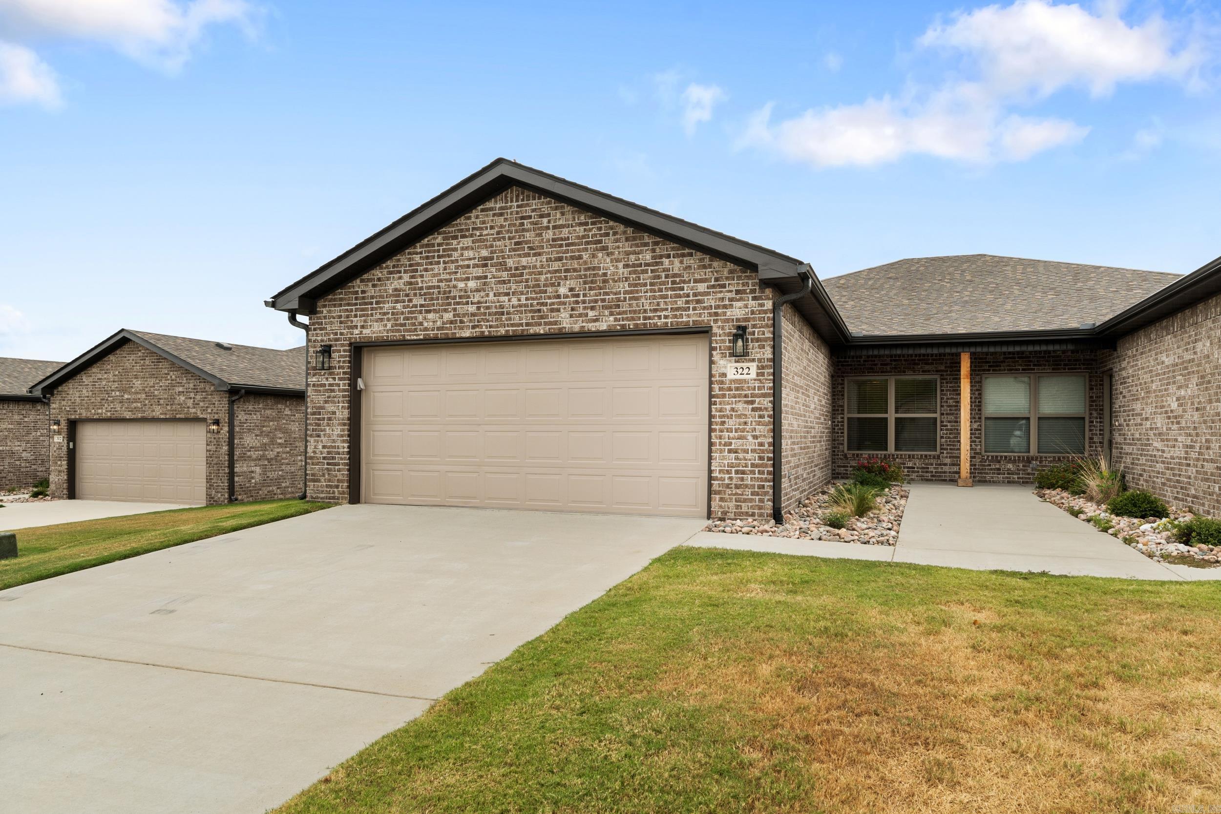 Now available in the prestigious Big Creek Country Clubāthis 2023 newer construction patio home offers low-maintenance, energy-efficient living with timeless style. Thoughtfully designed all-brick home features 3 bedrooms, 2 bathrooms, and an attached 2-car garage. Step inside to an open-concept layout filled with natural light, luxury vinyl plank flooring throughout, and contemporary finishes. The kitchen shines with Kemper white shaker cabinets, cabinet hardware, and stainless steel appliancesādishwasher, range, microwave, and full-size refrigeratorāall included. A washer and dryer are also provided. Designed with convenience in mind, home includes 3-foot-wide doorways, lever-style hardware, walk-in closets, 2" blinds, full gutter systems, and covered rear patios for outdoor enjoyment. Just minutes from golf, dining, and local amenities, these homes combine style, comfort, and convenience in one of Mountain Homeās most desirable communities.