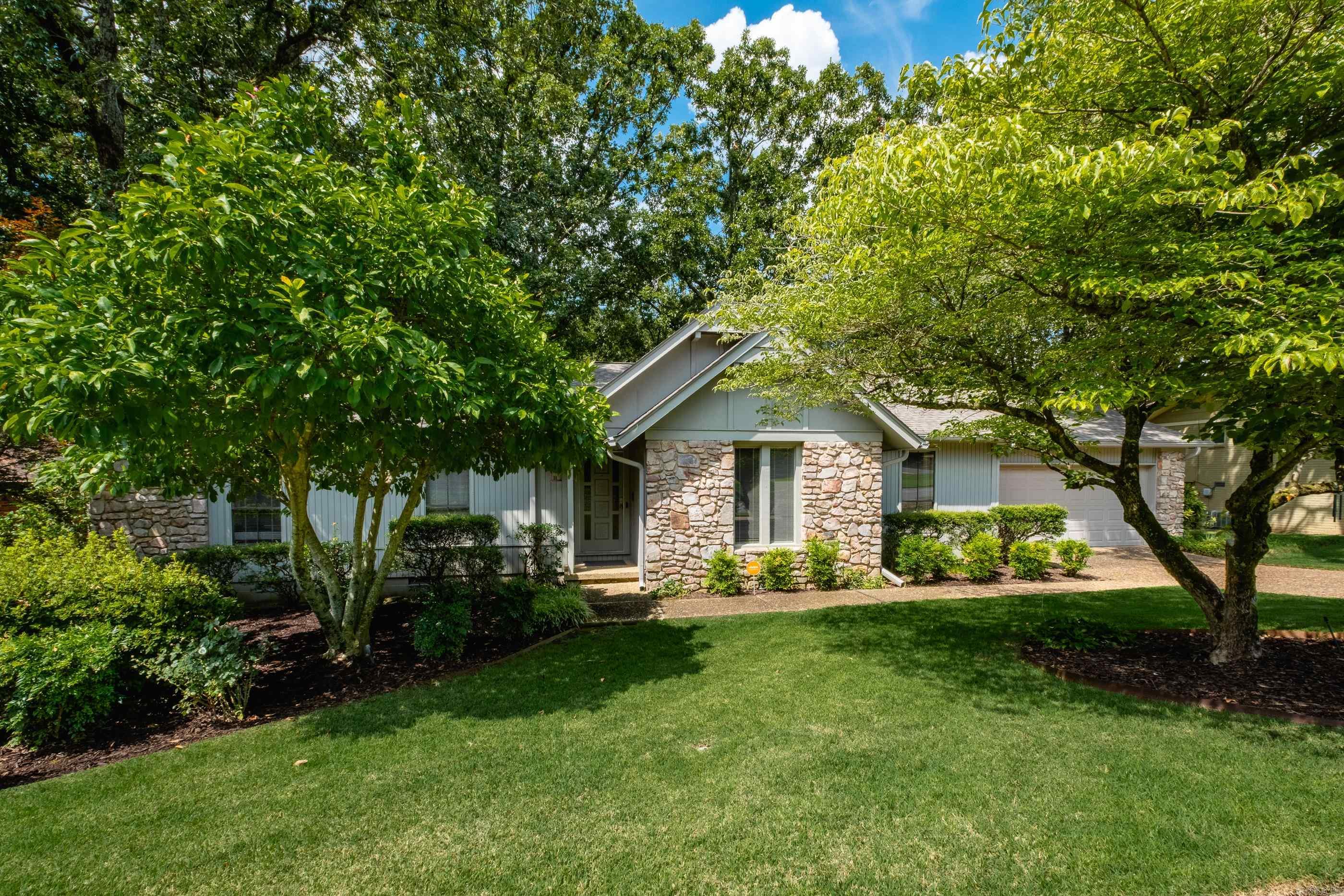 Lovely traditional home with great space for everyday living and entertaining. Fresh paint throughout, formal living and dining rooms, and a comfortable family den with gas start wood burning fireplace and parquet wood floors. Parquet continues through the hallway and primary bedroom, while guest bedrooms and formal spaces have carpet. The kitchen, laundry, and utility/pantry areas also with new tile floors. Eat in kitchen features breakfast nook, electric range and newer dishwasher. The hall bath was remodeled in 2021 with a quartz-topped vanity, new tile flooring, and a large tiled walk-in shower. The primary bath also features a new quartz vanity. Exterior is a mix of stone, brick, and wood with beautiful curb appeal, gorgeous landscaping and sprinkler system. Enjoy the large backyard with mature trees from the rear deck. Two car garage. New roof in 2021. Come see.