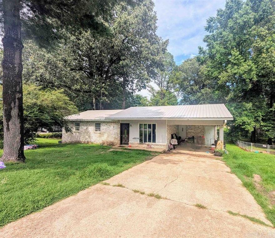 Take a look at this cozy brick home in a great location, just walking distance to the park!  This home offers a low-maintenance metal roof, spacious yard and carport for covered parking. A cute home that needs a little TLC to make it your own.