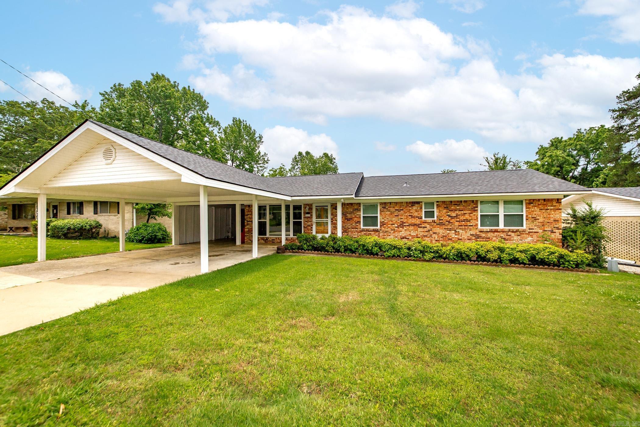 Charming home with income potential! Located in one of Hot Springsā most established neighborhoods, this 3-bedroom, 1.5-bath brick home offers both comfort and opportunity. Original hardwood floors add timeless charm, while energy-efficient upgradesāincluding insulated windows, storm doors, and a newer roofāensure low-maintenance living. The attached carport includes a storage area and laundry room, and the covered back patio overlooks a peaceful and private yard. Whether youāre looking for a move-in-ready family home or a solid investment with a long-term tenant already in place, this property checks all the boxes!