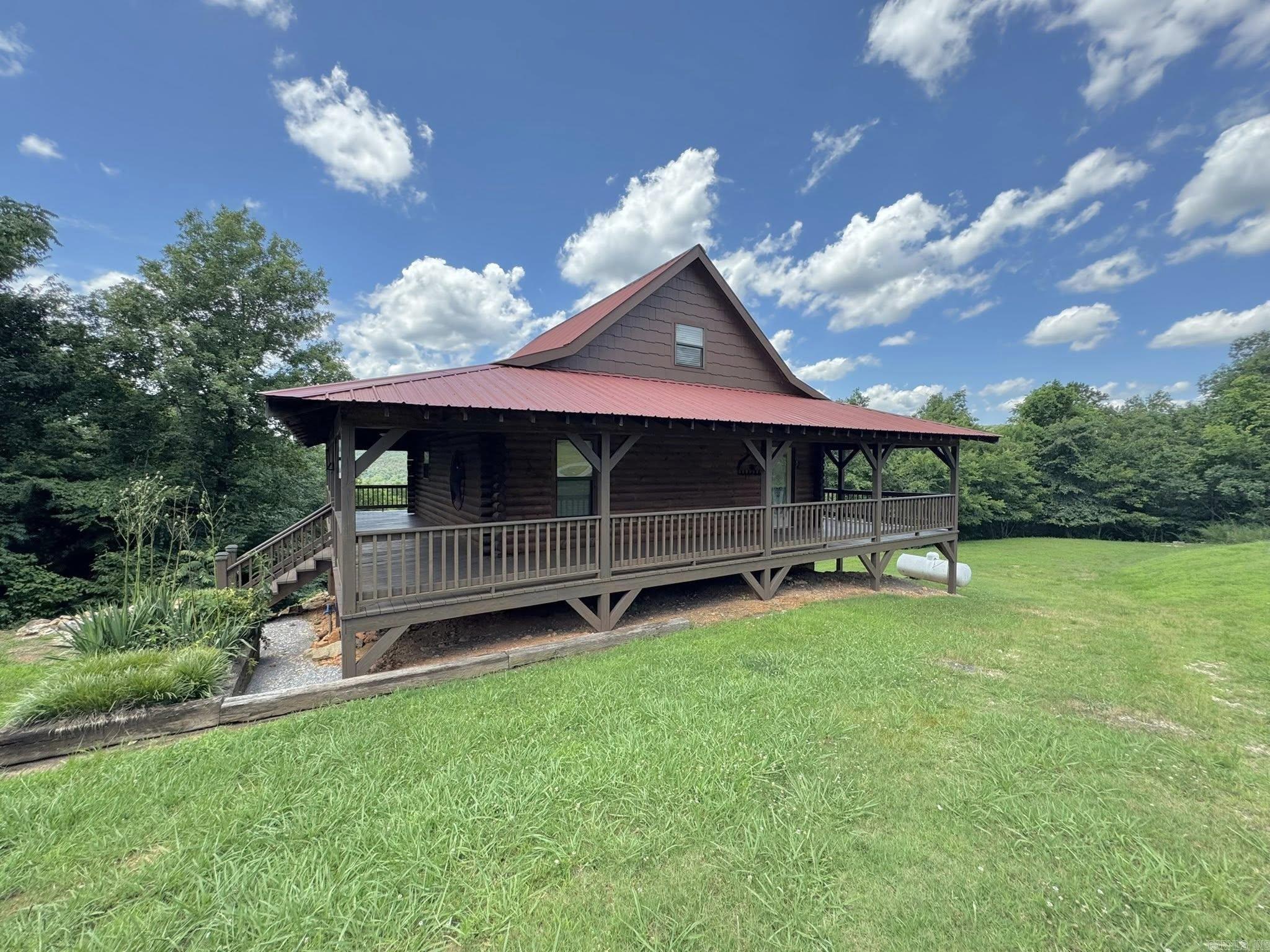 Endless Possibilities in Mountain View, Arkansas! This spacious 3-story home offers flexibility, functionality, and stunning viewsāperfect for full-time living, multi-generational use, or as an income-producing investment. Each floor features its own bedroom and full bathroom, offering privacy and convenience throughout. The main level boasts an open-concept living room and kitchen with direct access to a scenic deckāideal for entertaining or relaxing. The upper level includes a private suite with full bath and elevated views, while the walk-out basement features a third bedroom, full bath, laundry area, storm shelter/storage room, and a convenient kitchenette with cookstove and second refrigerator. With indoor and separate outdoor basement access, this space is perfect for guests, short-term rentals, or extended stays. Enjoy both upper and lower decks to take in the breathtaking views of the Ozarks. Whether you're looking for a peaceful place to call home or a great short-term rental opportunity near downtown Mountain View, this one is worth a look!