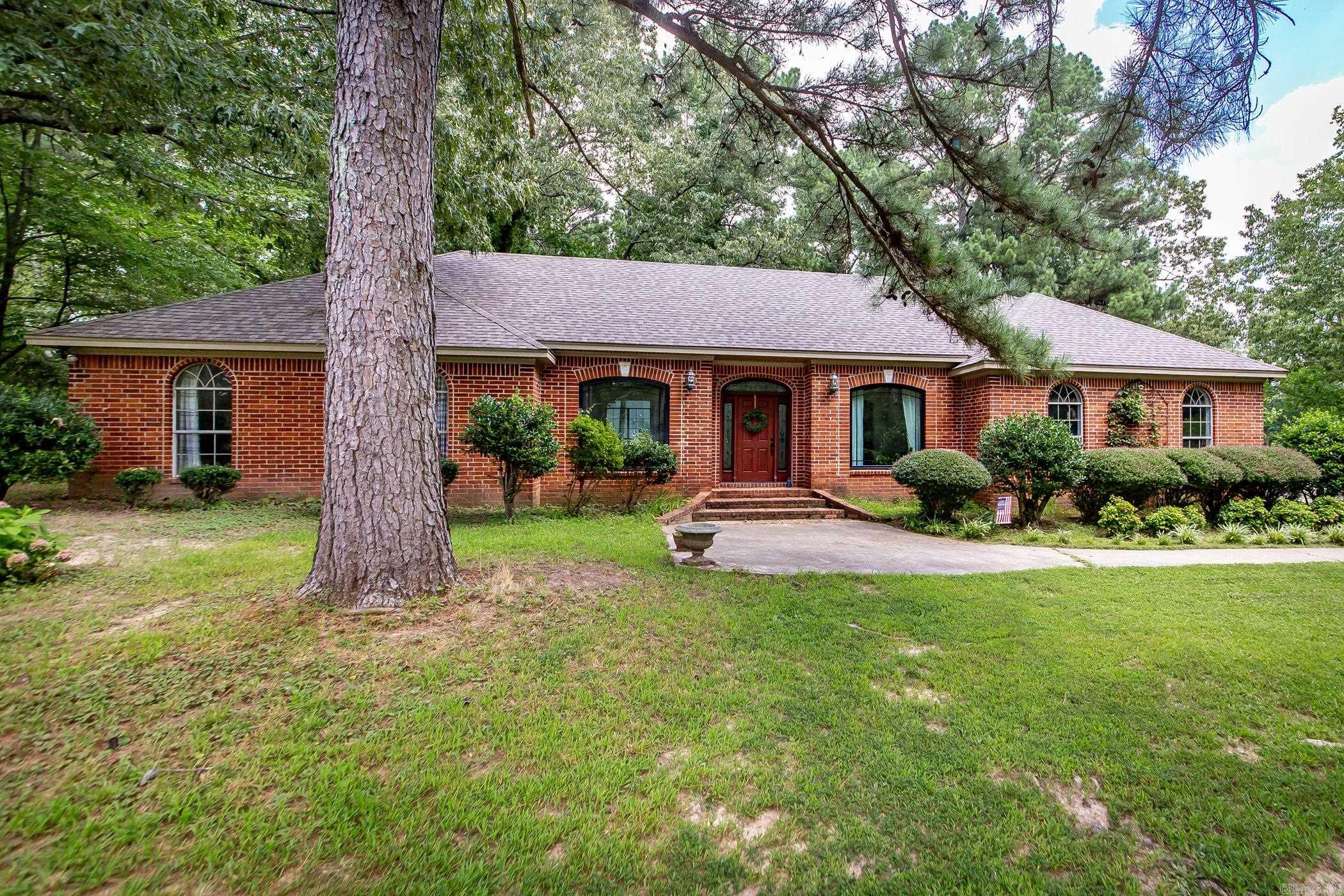 What a beauty! As you drive to this home, you will feel the tranquility of peace through the huge trees cascading the roadway-so serene! All brick home with 3 stall barn for horses (3 max allowed). Home has been remodeled in 2018 with new roof, new flooring, new appliances and new kitchen! Fireplace with new gas logs also. You will love the soft blue painted cabinets and the white quartz countertops and yes, for the cook of the family... two sinks!!!! Enjoy the open friendly living area for family gatherings! Brand new Anderson windows in living and dining area and two bedrooms welcoming the taste of nature and beauty into your home. Separate office for those working from home. RV hookups also on the property for power and sewer.