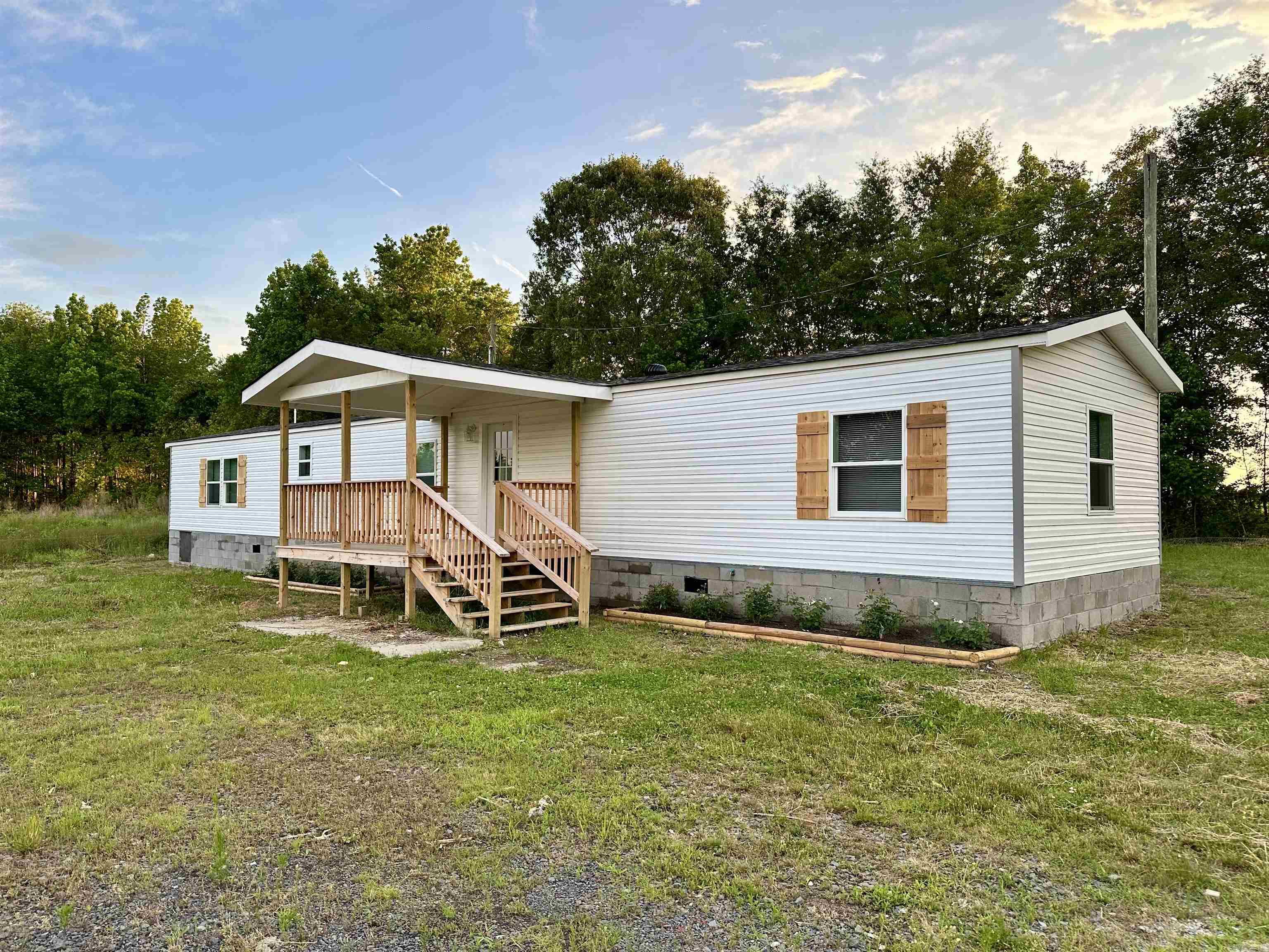 Enjoy living out in the country? Well check out this renovated manufactured home on 3 acres of FLAT LAND! This move-in ready home has 3 bedrooms and 2 baths, an open concept design features a layout where the living, dining, and kitchen areas are interconnected, allowing for greater flexibility and a more spacious feel. Fresh paint and new vinyl flooring throughout the house. Updated bathrooms with beautiful tiles! New deck to relax and enjoy your yard! Please schedule your showing now!