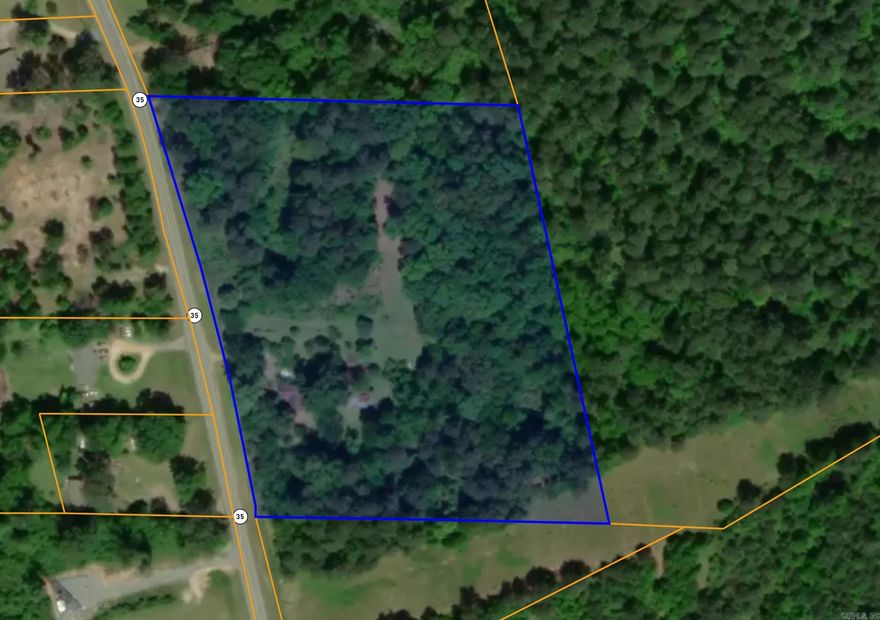 Wooded five acre parcel for sale on larger tract. Hwy 35 frontage. Utilities are at the street. Seller does not have a survey on file.